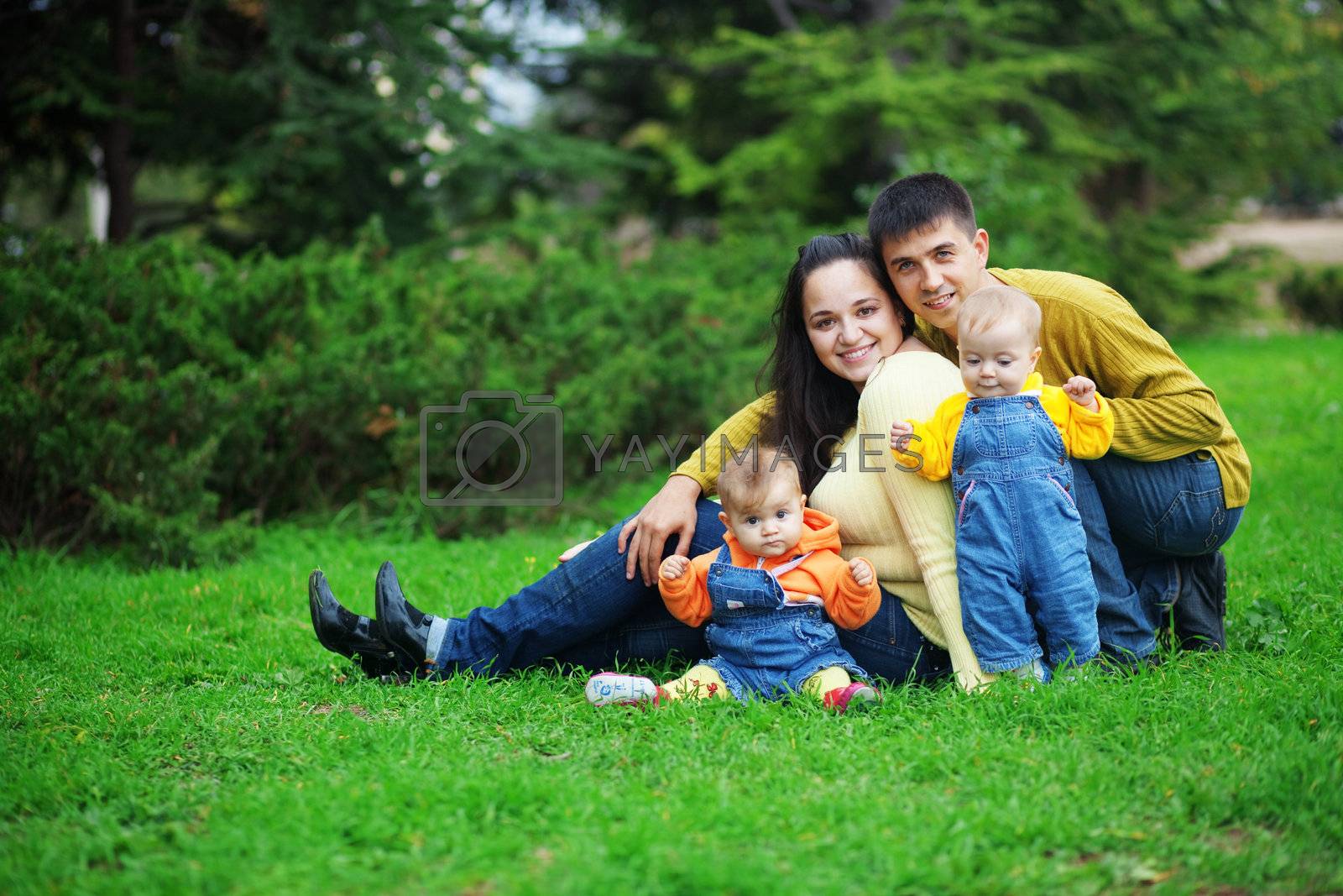 Royalty free image of Happy parents with twins by alenkasm