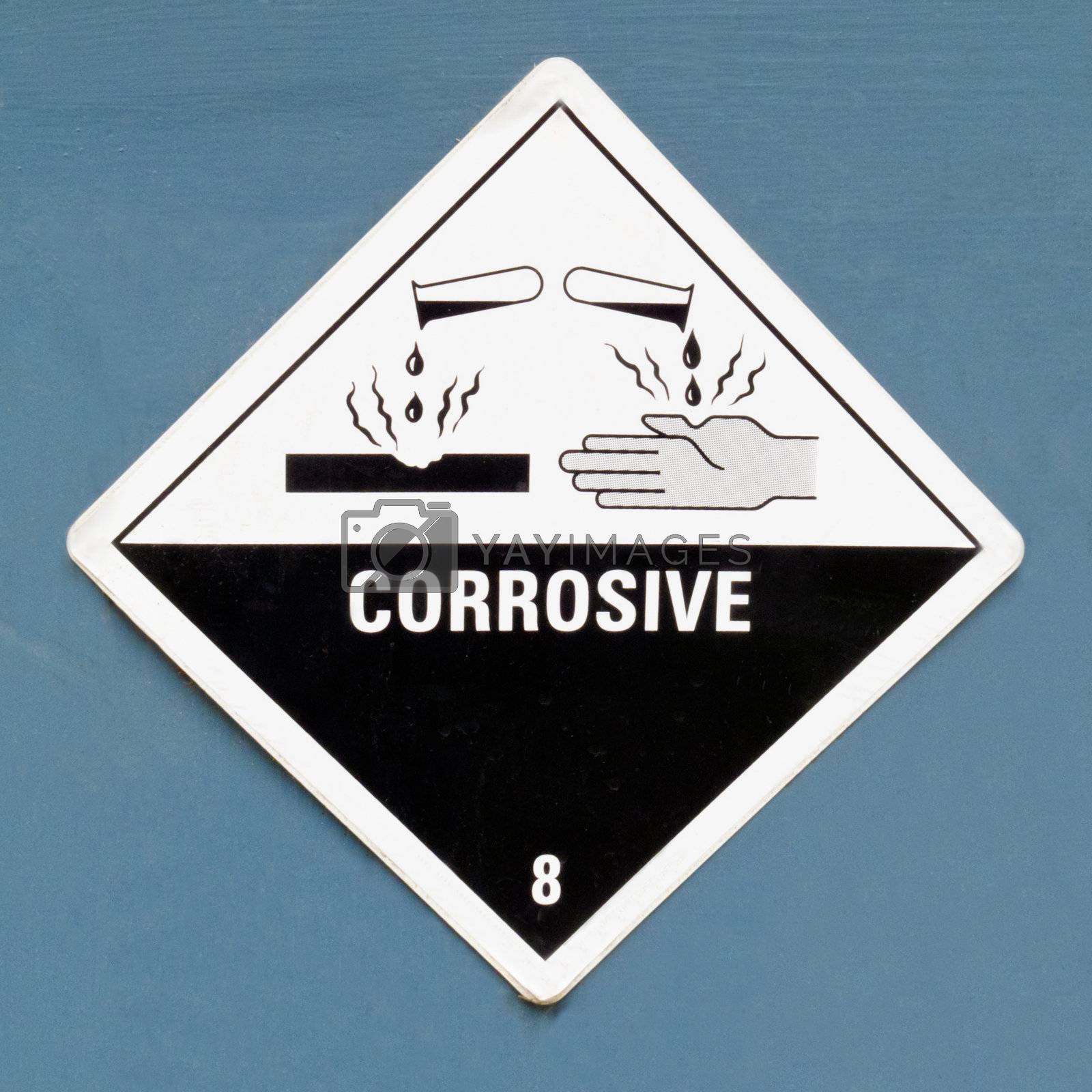 Corrosive hazard symbol warning sign on blue Royalty Free Stock Image ...