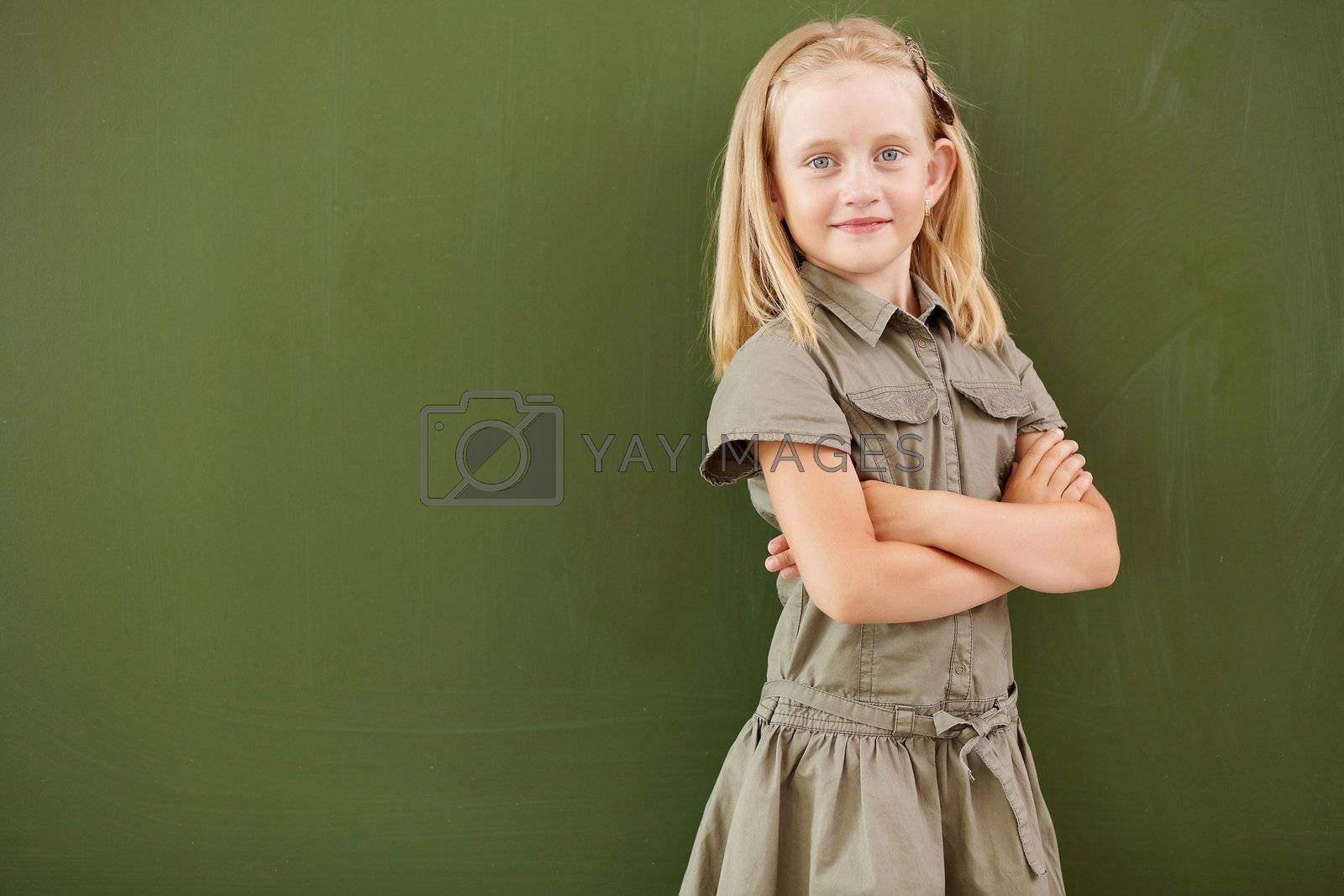 Royalty free image of Scoolgirl standing near blackboard by sergey_nivens