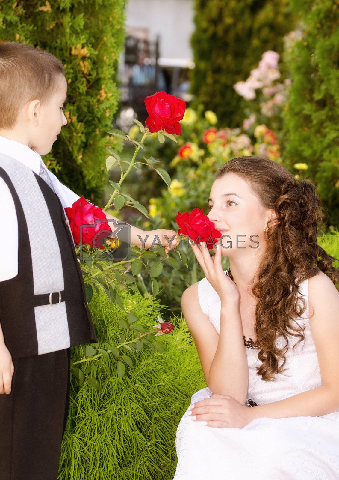 Little boy giving a rose to a beautiful girl