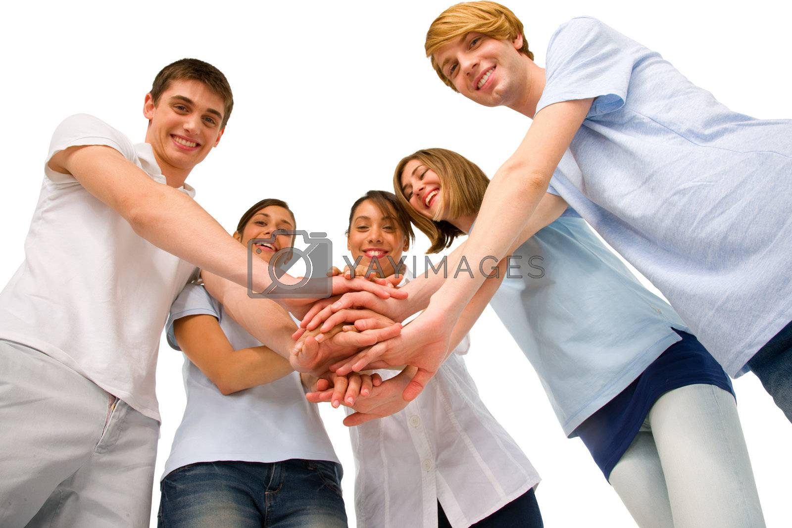 Royalty free image of teenagers with hands together by ambro