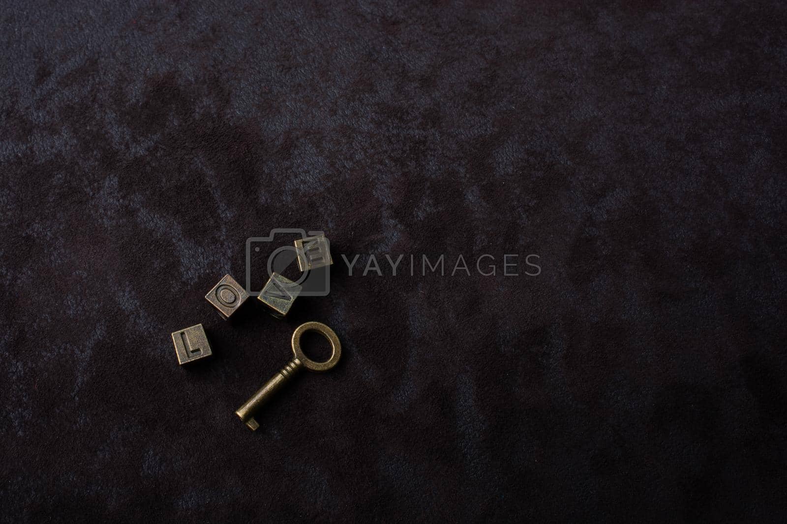 Royalty free image of Key and love wording on a dark background by berkay