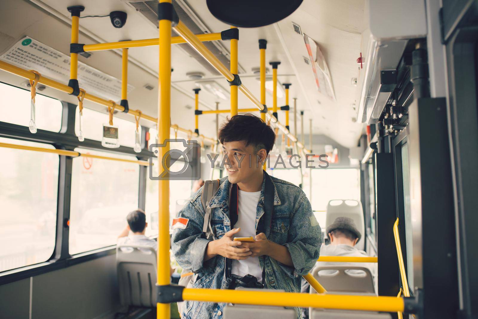 Royalty free image of People in the bus. Asian man using smartphone in public transport by makidotvn
