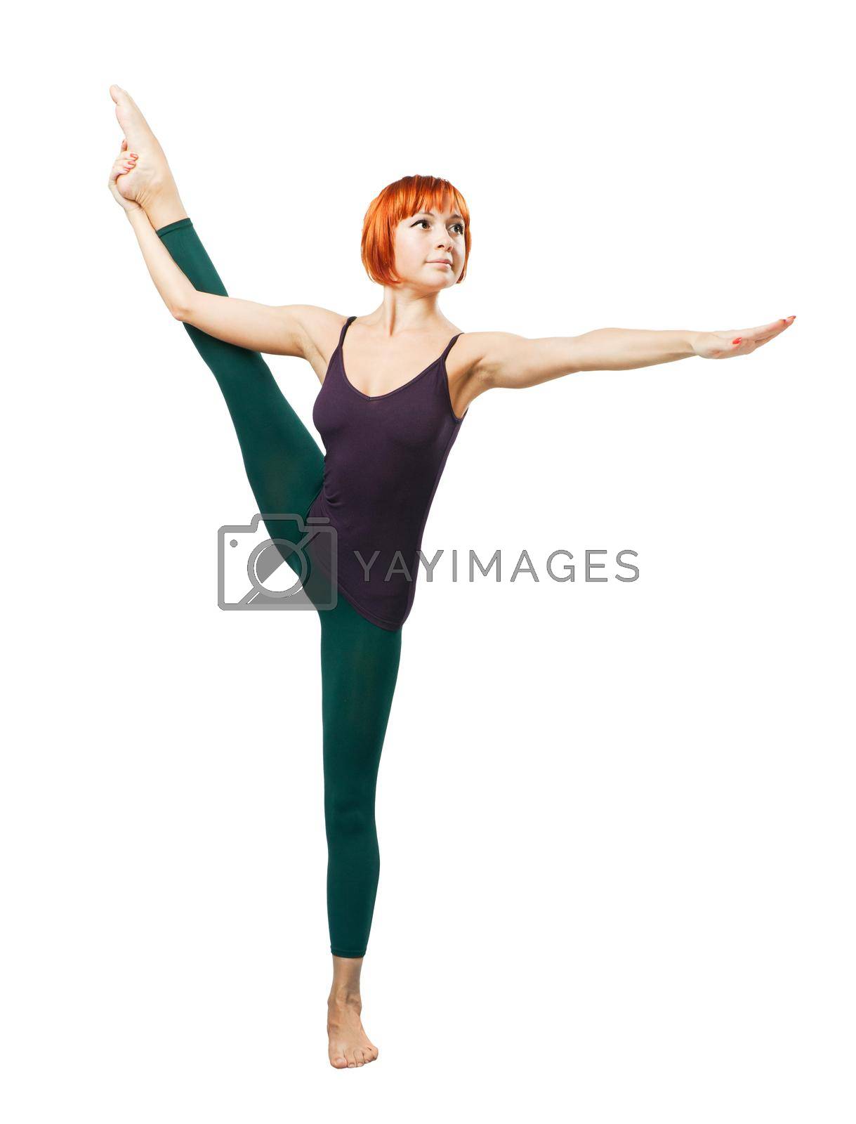Slim beautiful woman practicing yoga asana standing on one leg