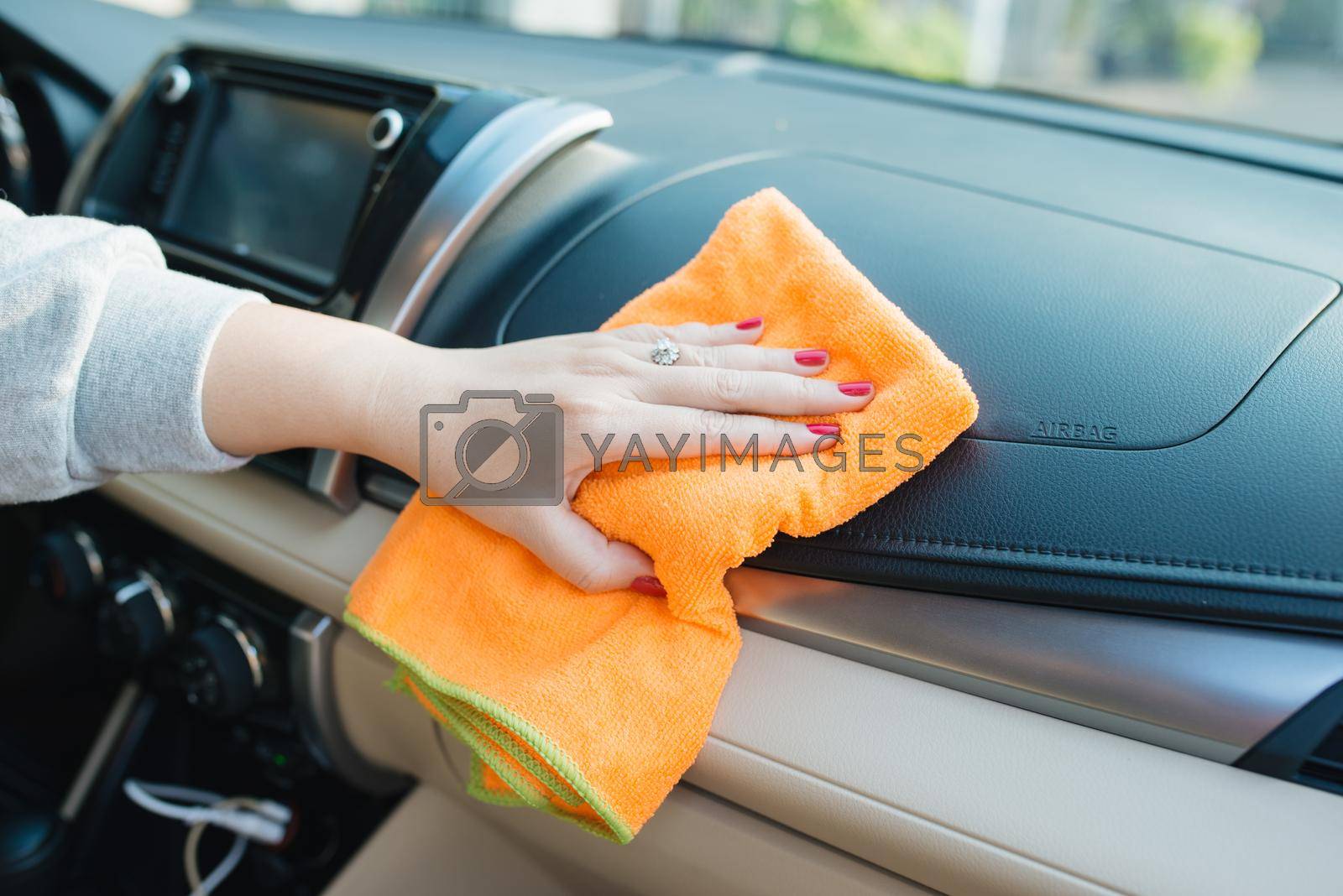 Royalty free image of Hand with microfiber cloth cleaning seat, auto detailing and valeting concept, washing car care interior, selective focus by makidotvn