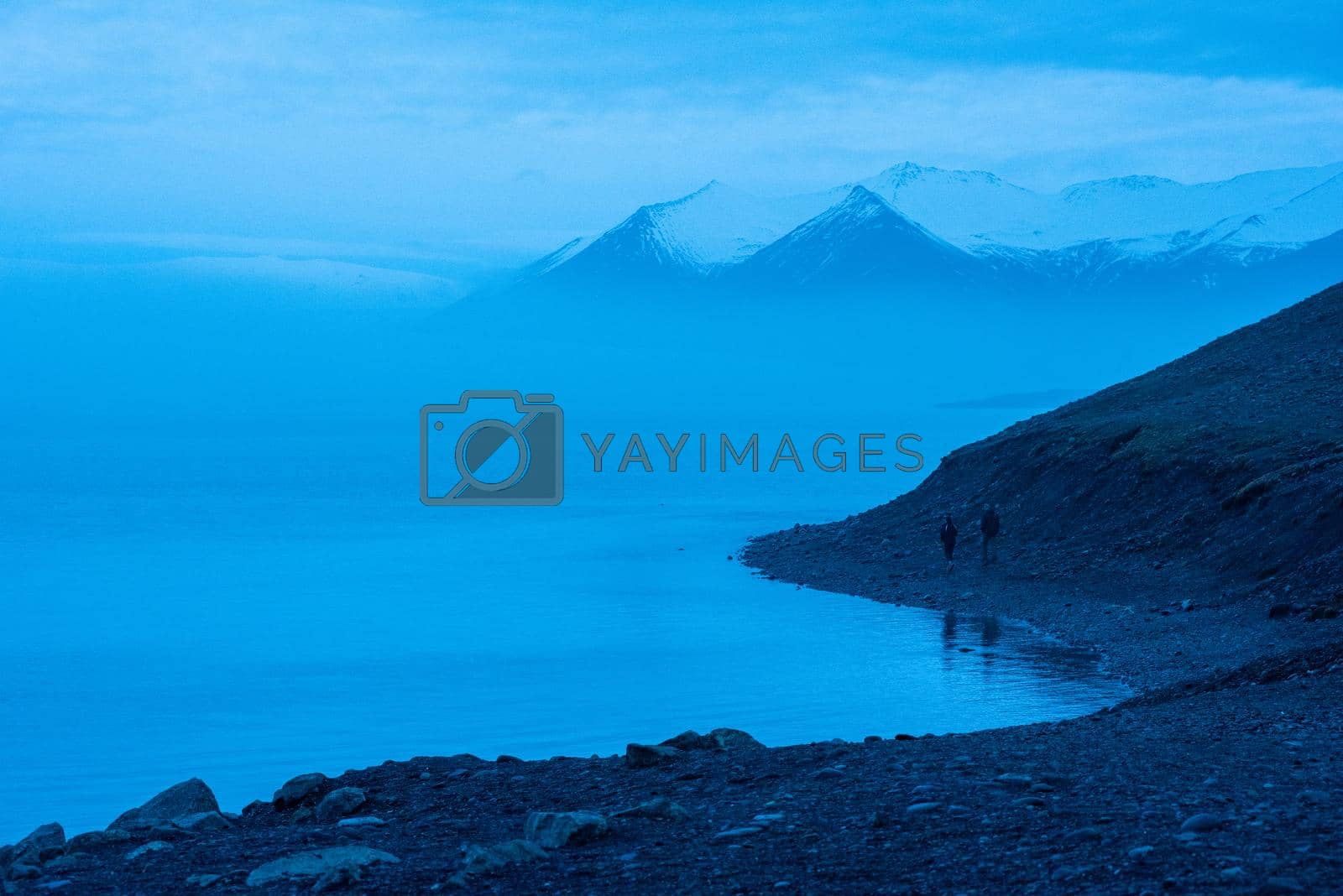 Royalty free image of Icelandic glacier floating with volcanic ash in it by jyurinko