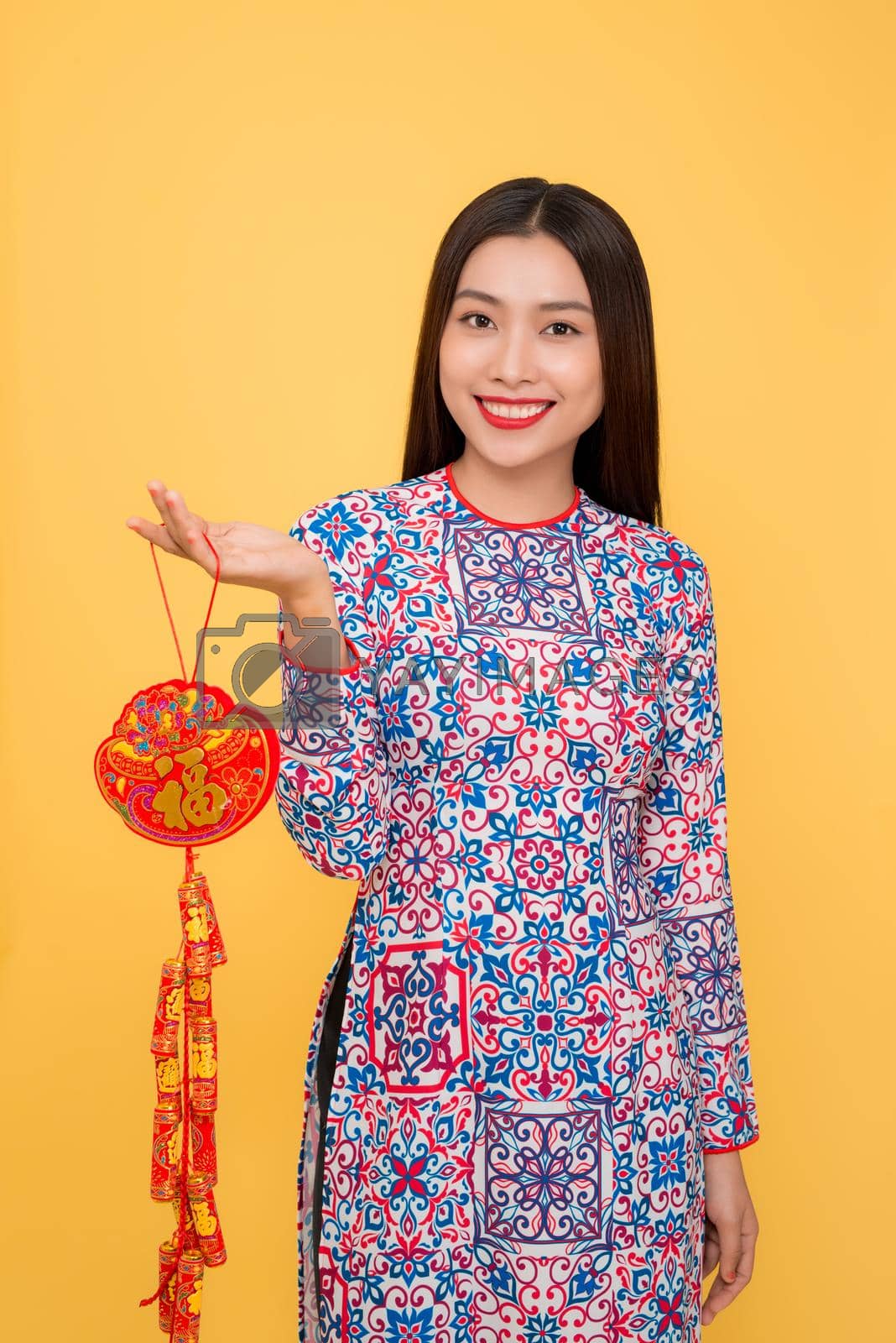 Royalty free image of Vietnamese woman holding attributes. Tet holiday. Lunar New Year. Text mean Happiness by makidotvn