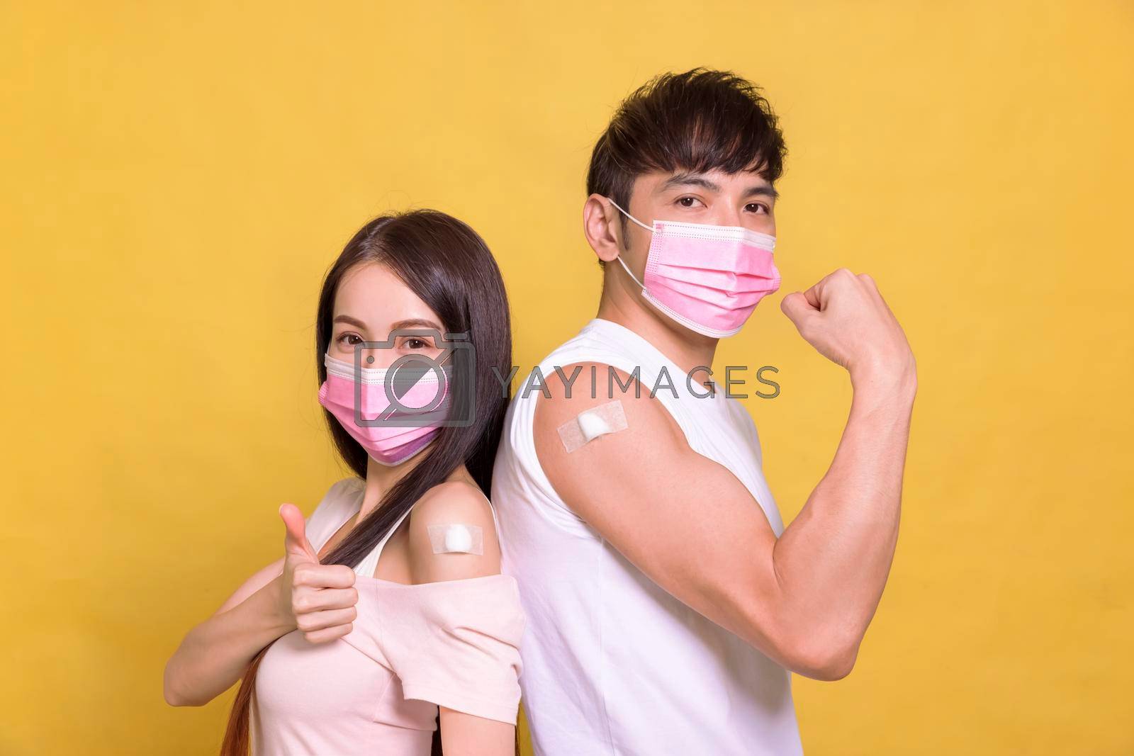 Royalty free image of Young couple  receive covid-19 anti virus vaccine and showing thumbs up by tomwang