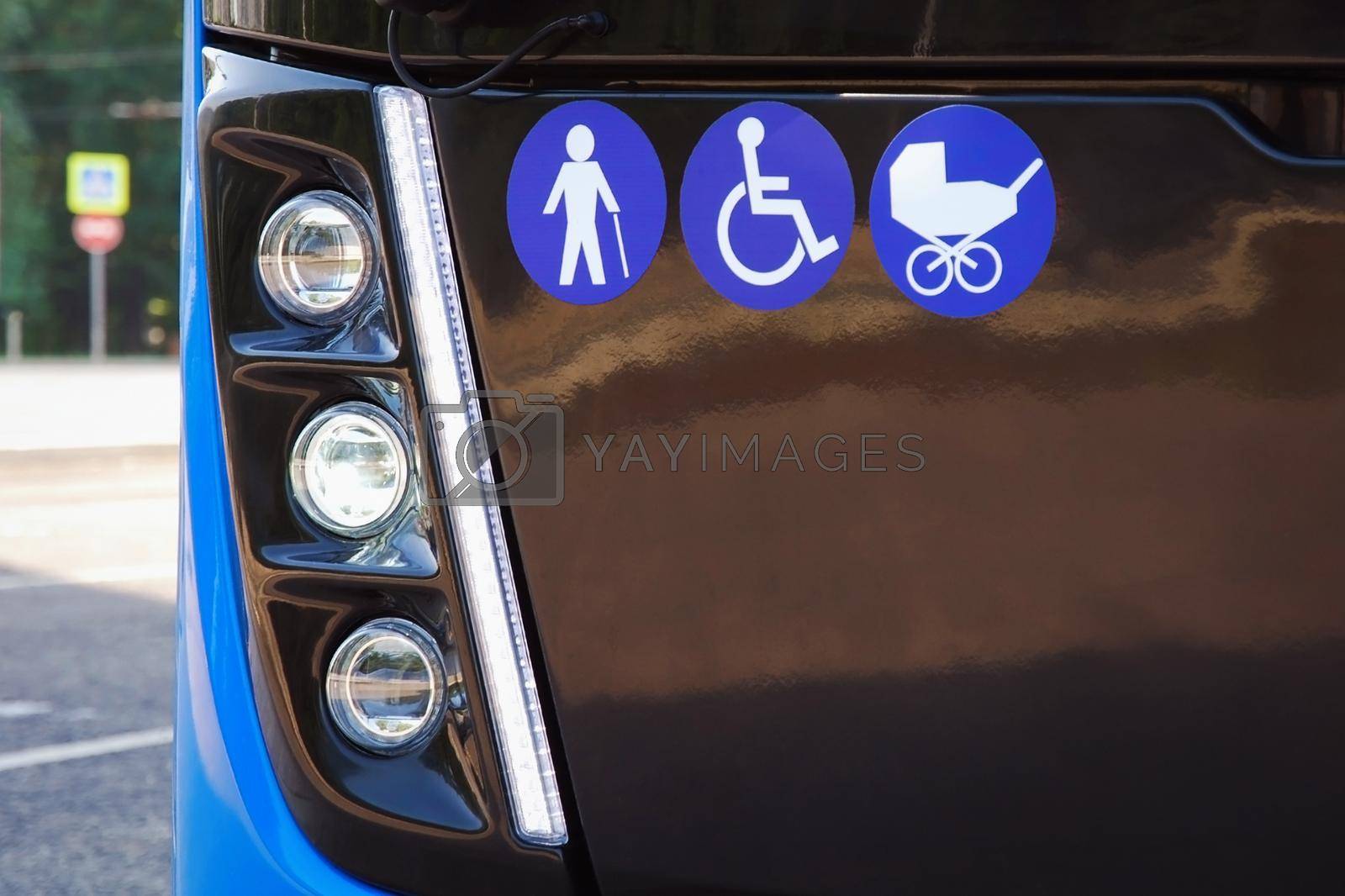 Signs of elderly, disabled person and baby carriage on city bus - public transport accessible for seniors and people with disabilities and children