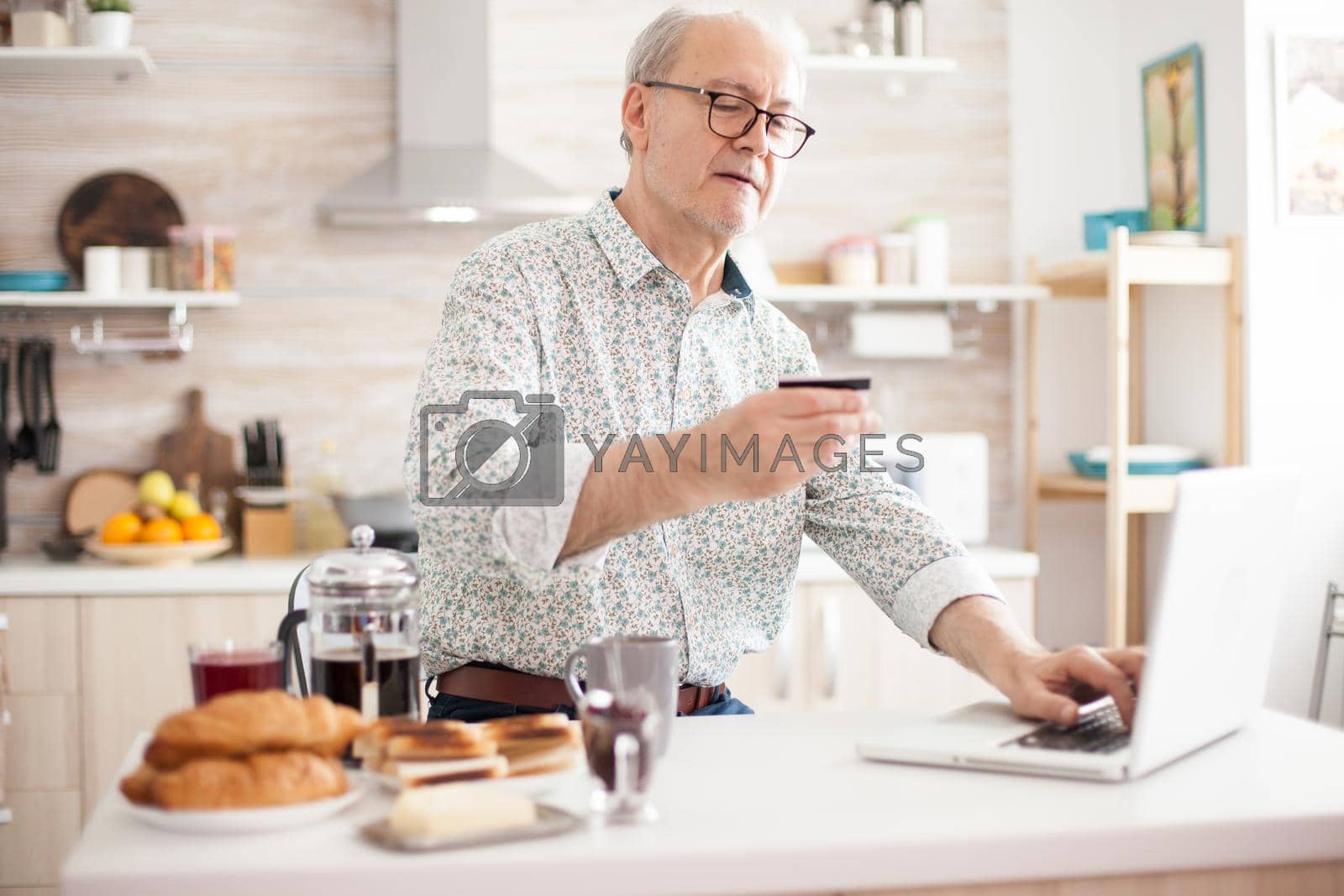 Royalty free image of Pensioner entering pin number by DCStudio