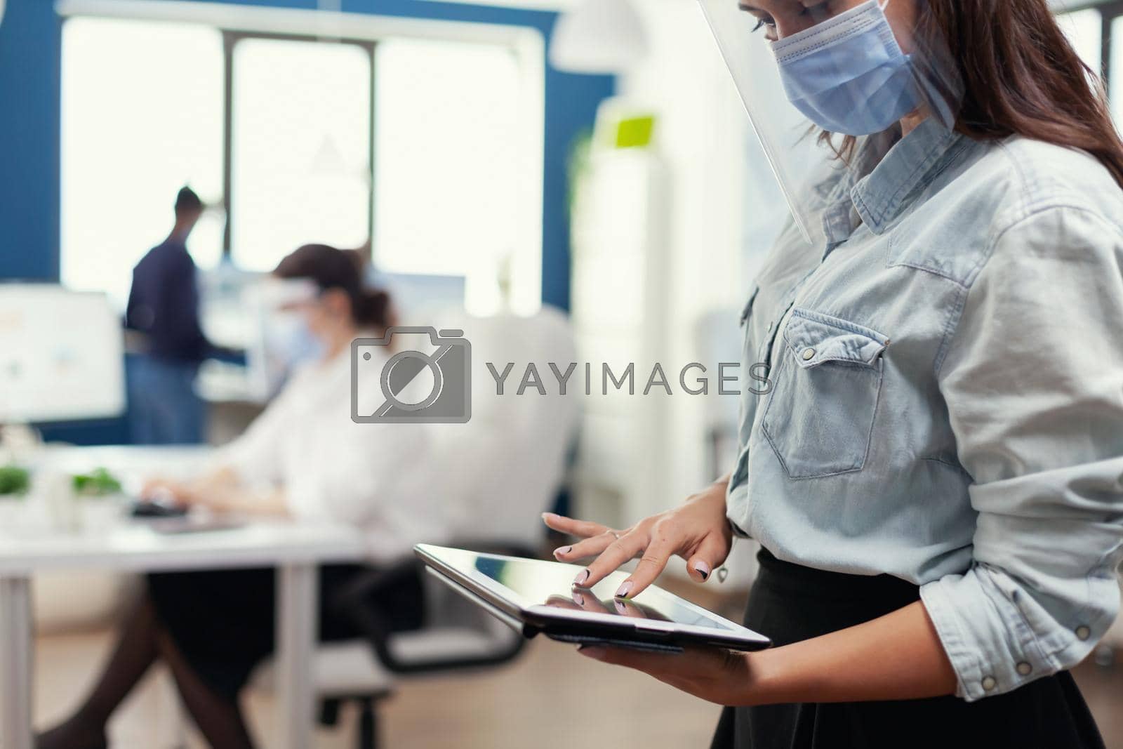 Royalty free image of Employee from marketing department checking company statistics by DCStudio