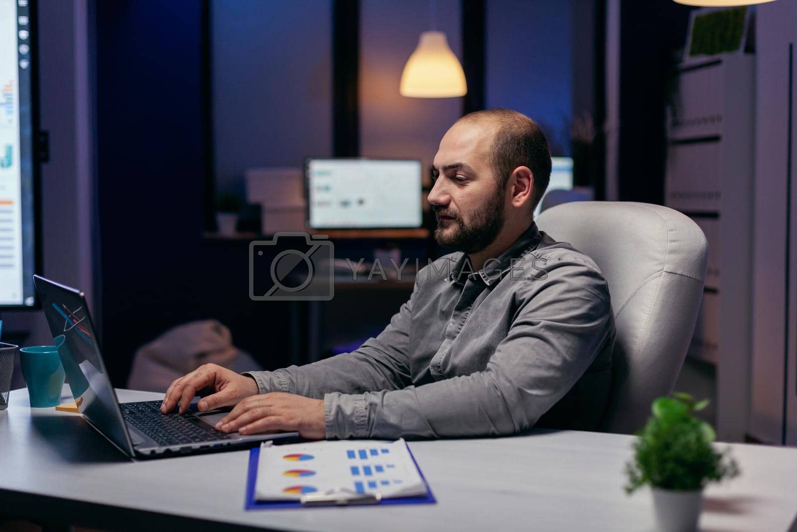 Royalty free image of Concentrated young businessman working in office by DCStudio
