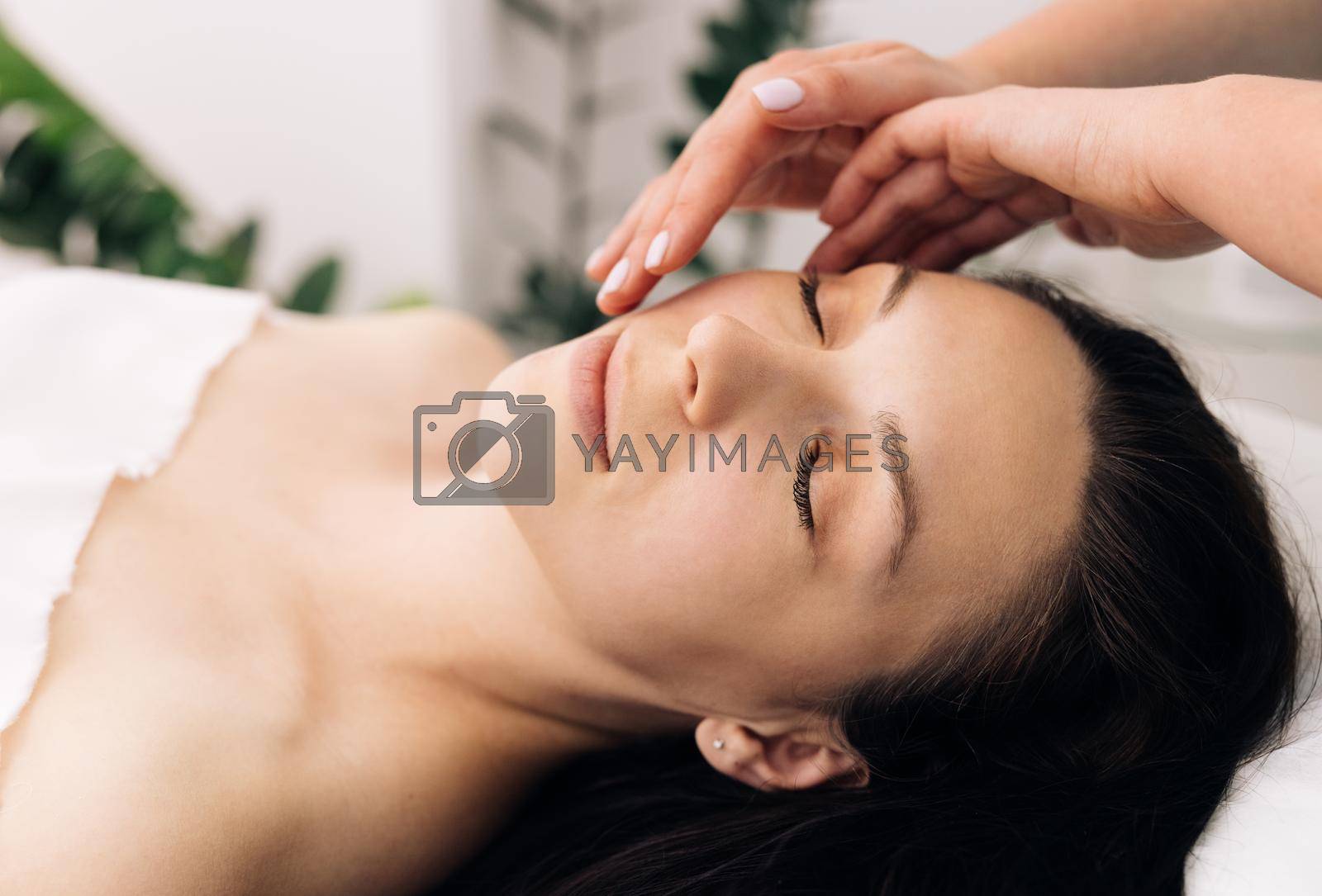Royalty free image of Beauty Treatments. Body care, skin care, wellness, wellbeing, beauty treatment concept. Face Massage in beauty spa salon. Spa facial Massage by uflypro