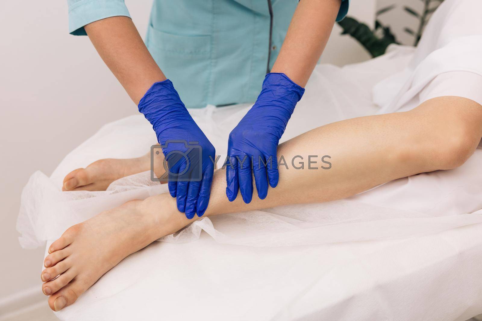 Royalty free image of Physiotherapist worker woman assisting physical medical exercise recovery after injuries. Rehabilitation. Treatment Healthcare Concept by uflypro