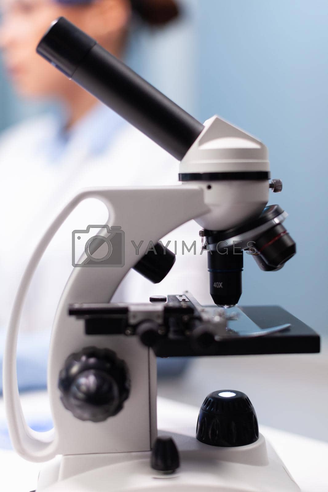 Royalty free image of Selective focus on medical microscope standing on table in pharmacology microbiologist hospital laboratory by DCStudio