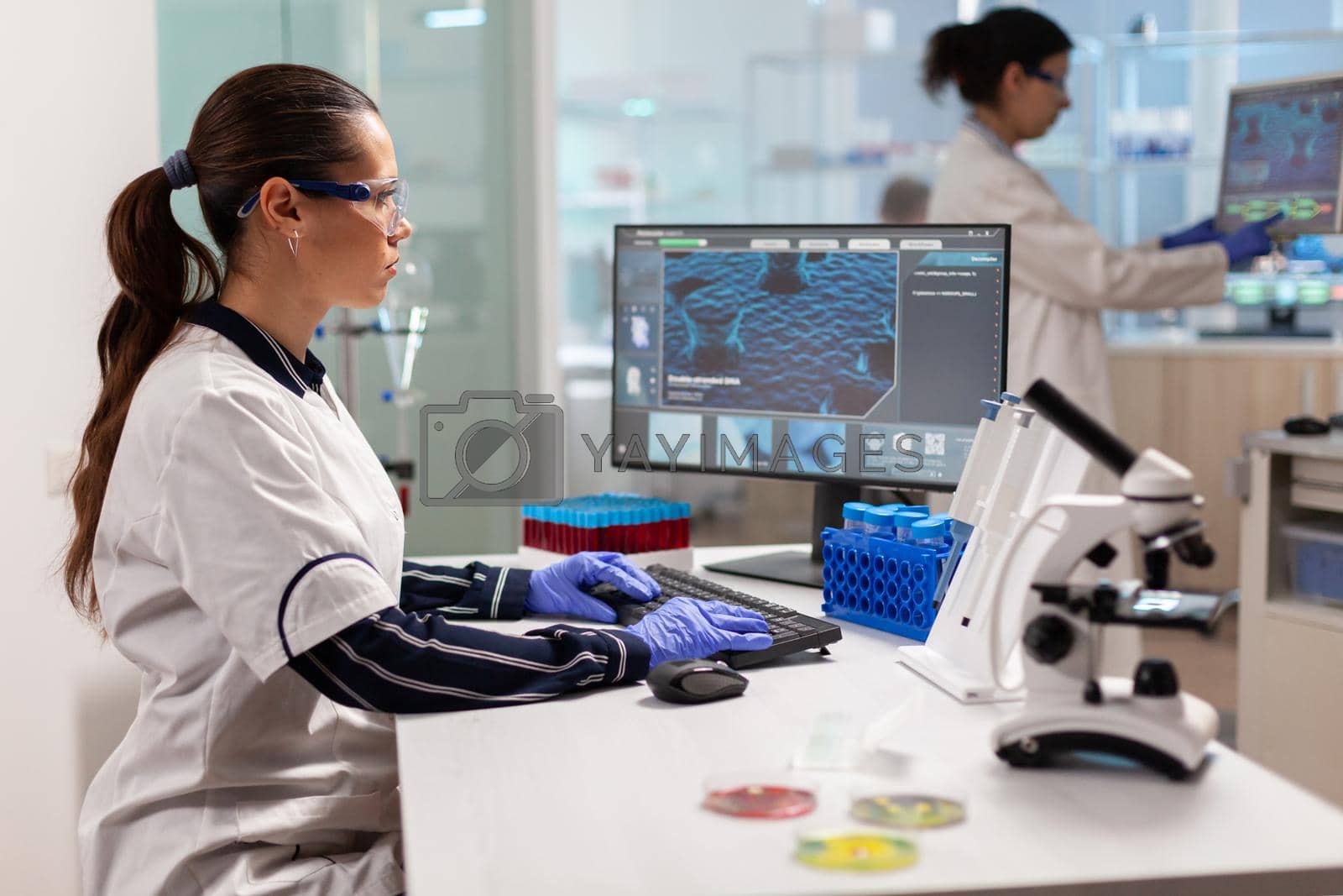 Royalty free image of Medical researcher working to develop a new vaccine in modern laboratory by DCStudio