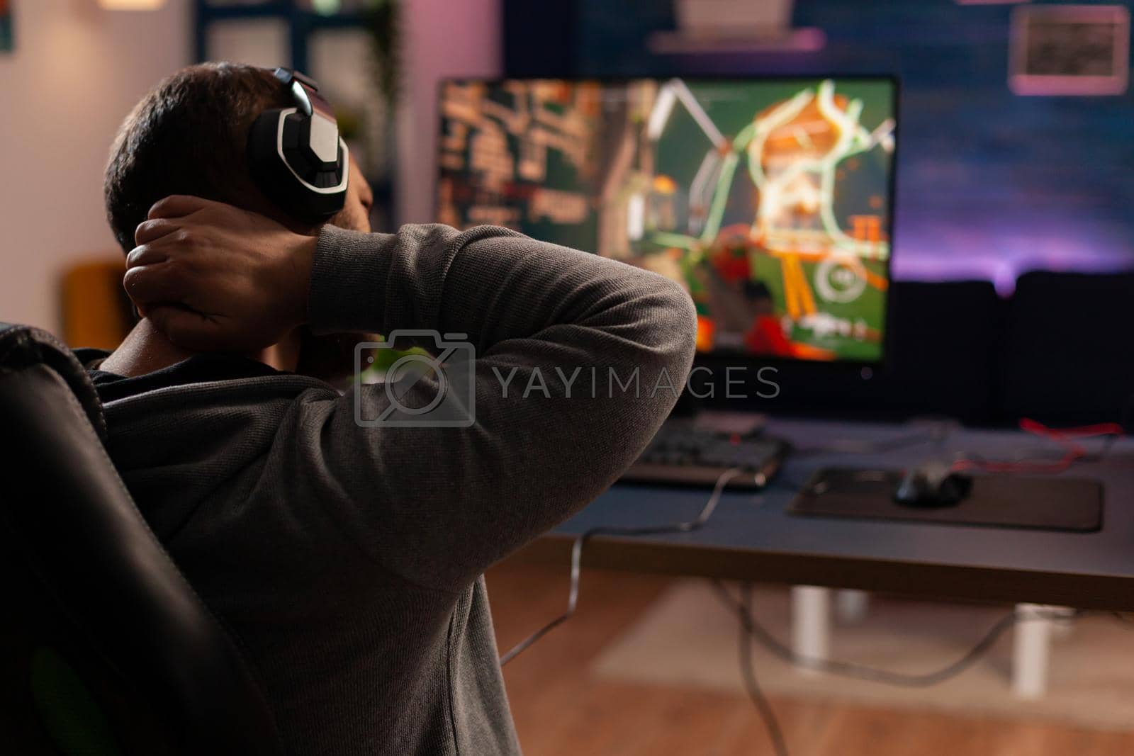 Royalty free image of Professional player playing shooter videogame by DCStudio