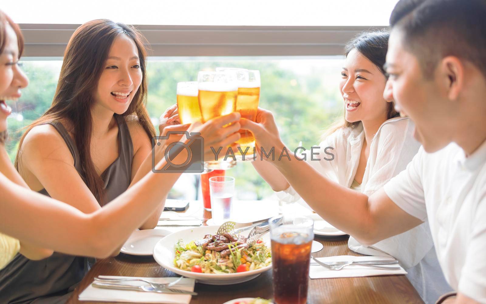 Royalty free image of Happy Young group enjoying food and drink in restaurant by tomwang
