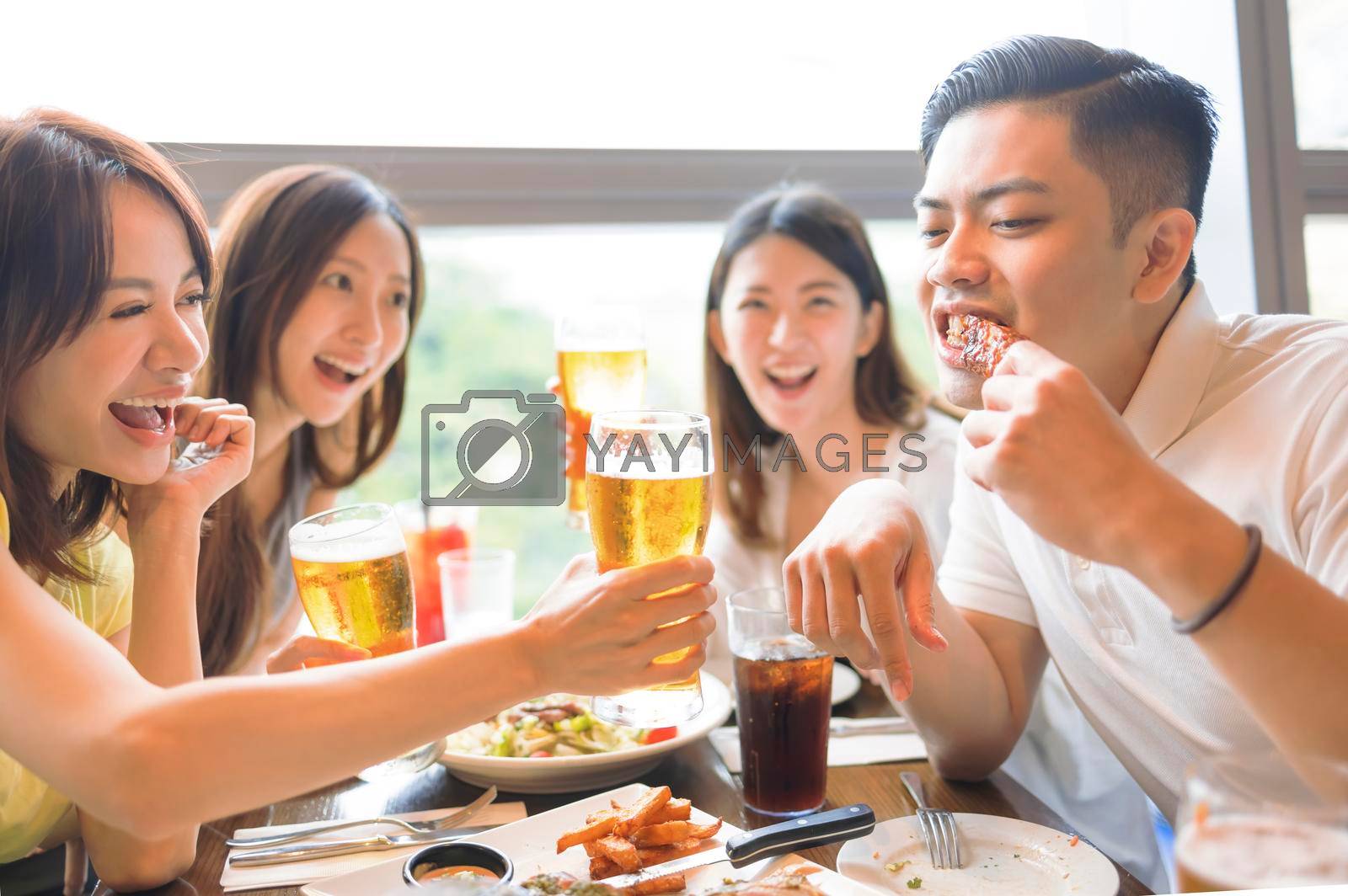 Happy  friends enjoying food and drink in restaurant