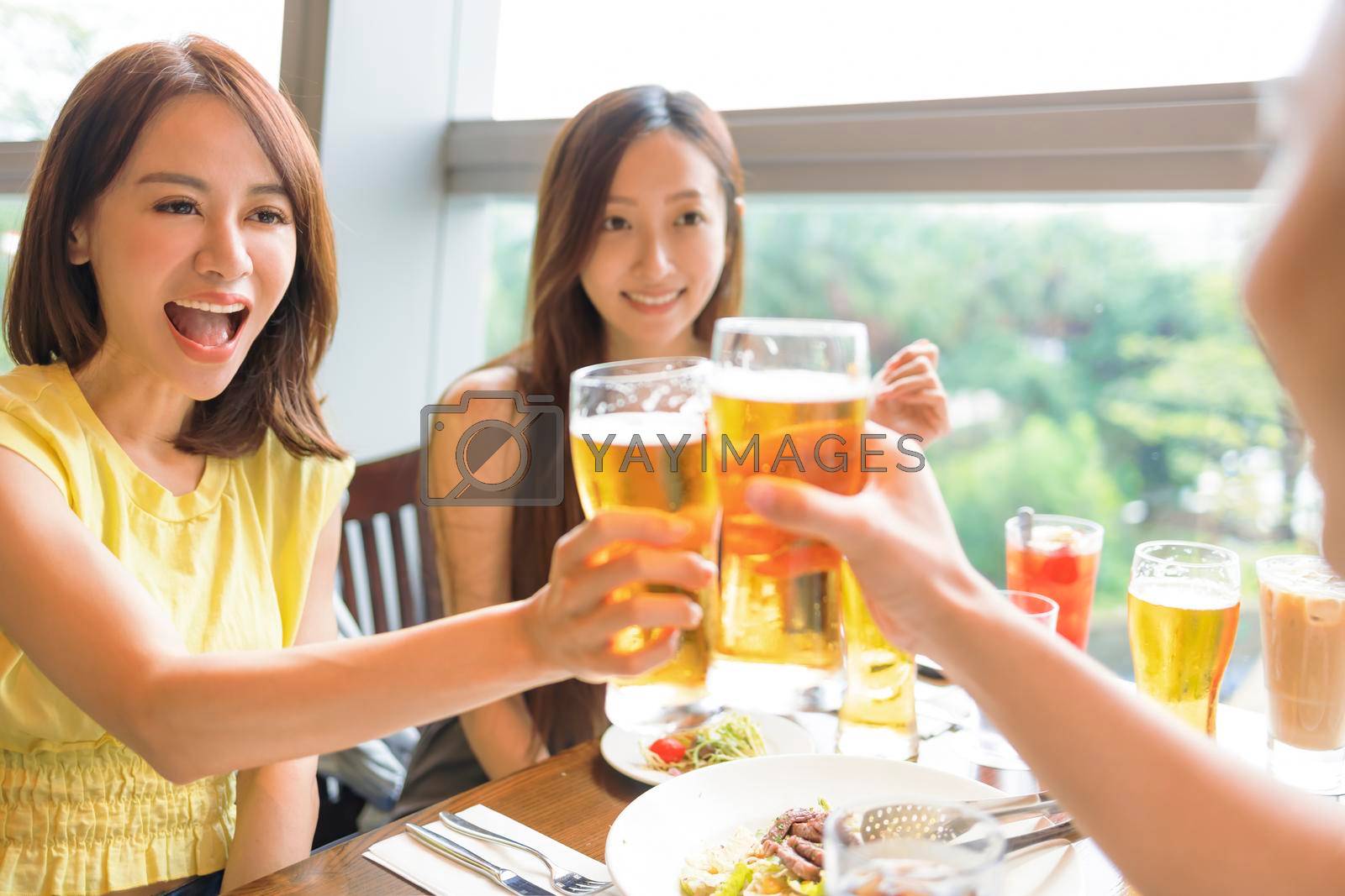 Happy Young group enjoying food and drink in restaurant