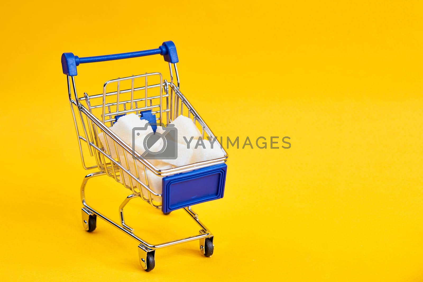 Royalty free image of carts with groceries shopping supermarket store yellow background by Vichizh