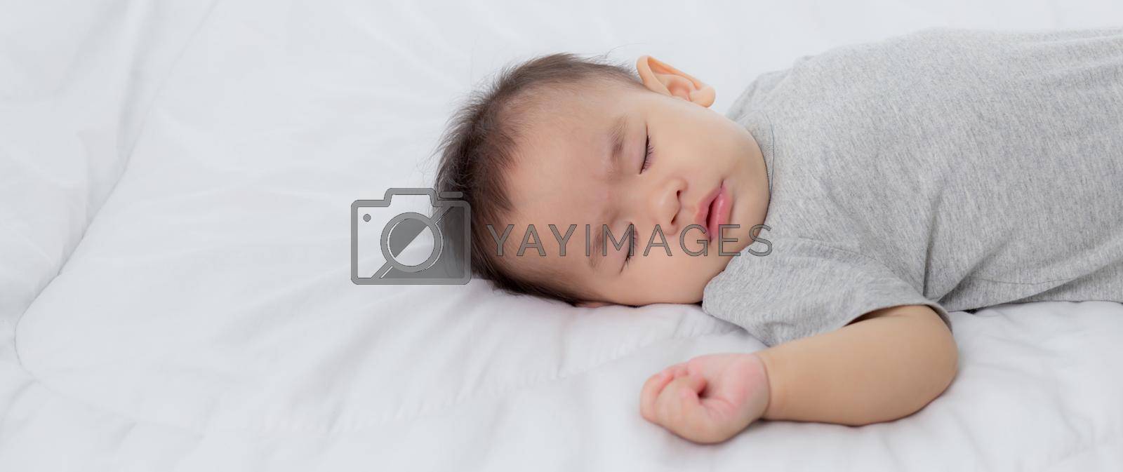 Royalty free image of Portrait of asian little baby girl sleeping on bed in the bedroom at home, newborn napping with cozy and relax, infant innocence in bedtime, happy toddler cute, growth of child and emotion, indoors. by nnudoo