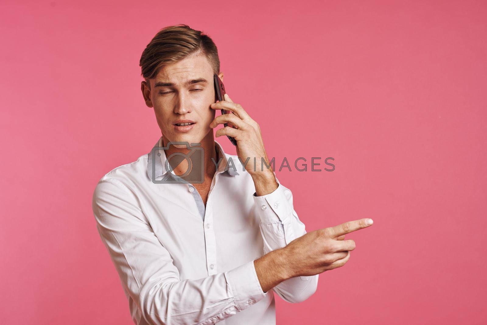 handsome man technology communication emotions pink background. High quality photo