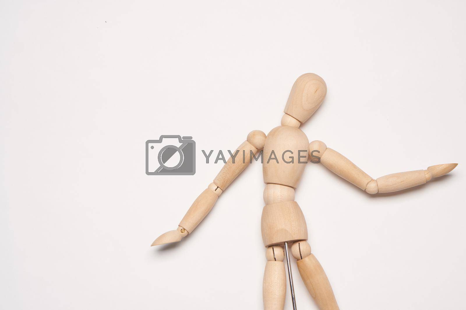 Royalty free image of wooden mannequin object close up light background by Vichizh