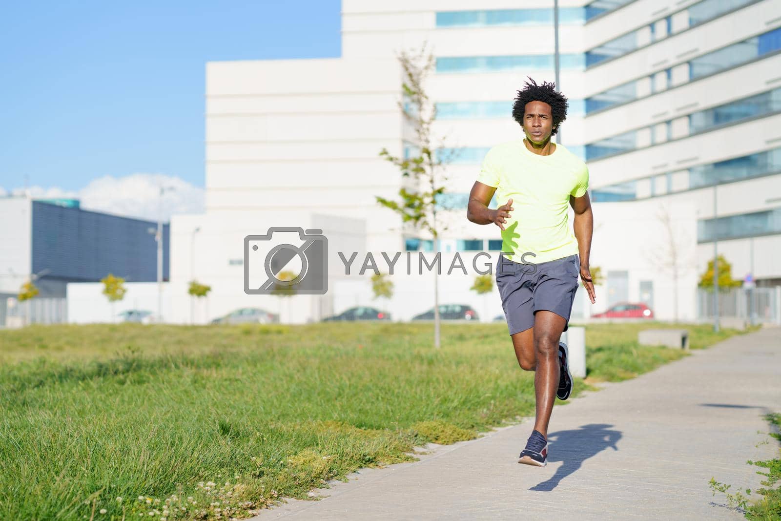 Royalty free image of Black athletic man running in an urban park. by javiindy