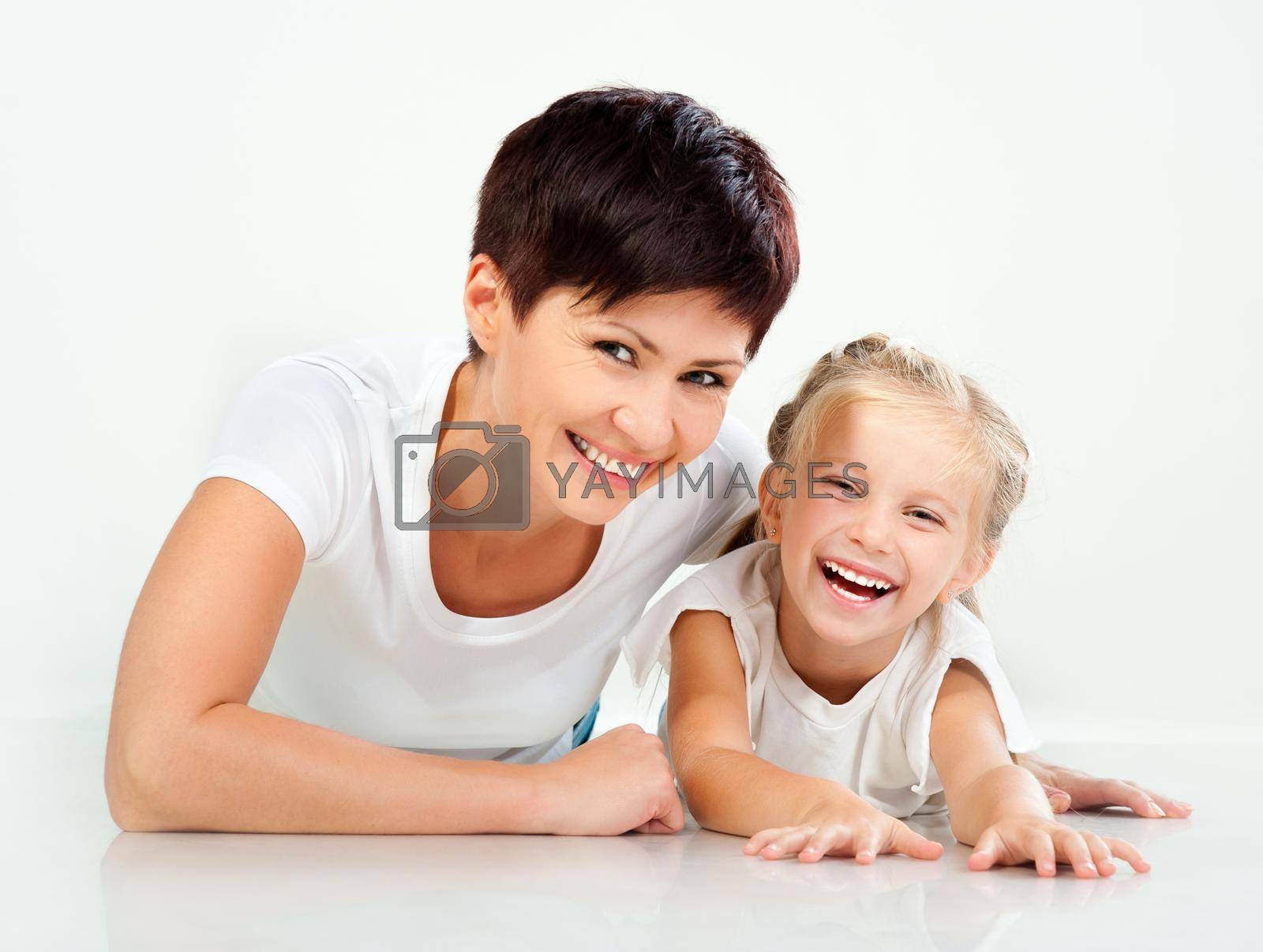 Mother and daughter laughing and looking at camera