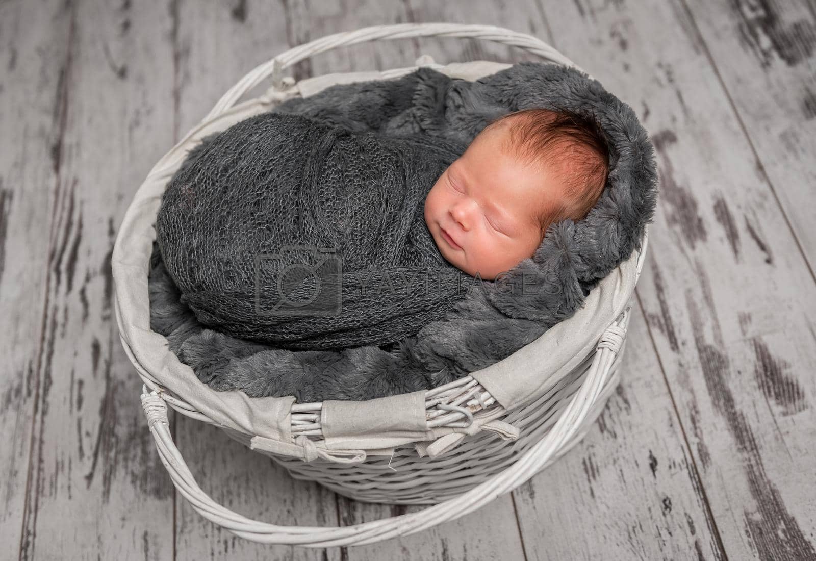 Royalty free image of Innocent infant napping in cradle by tan4ikk1