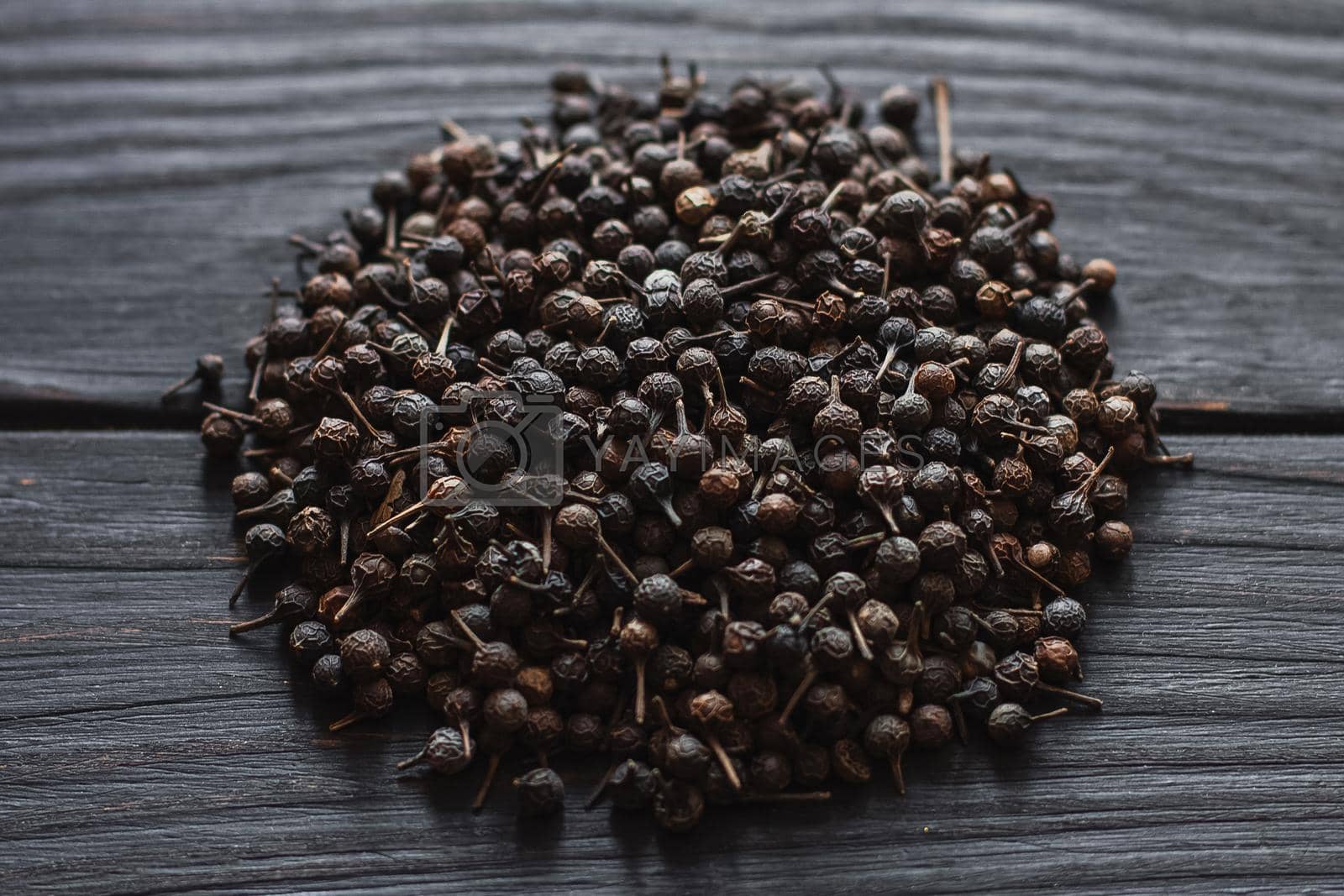 Royalty free image of Black pepper grains, peppercorns seeds on a background close up macro by mmp1206