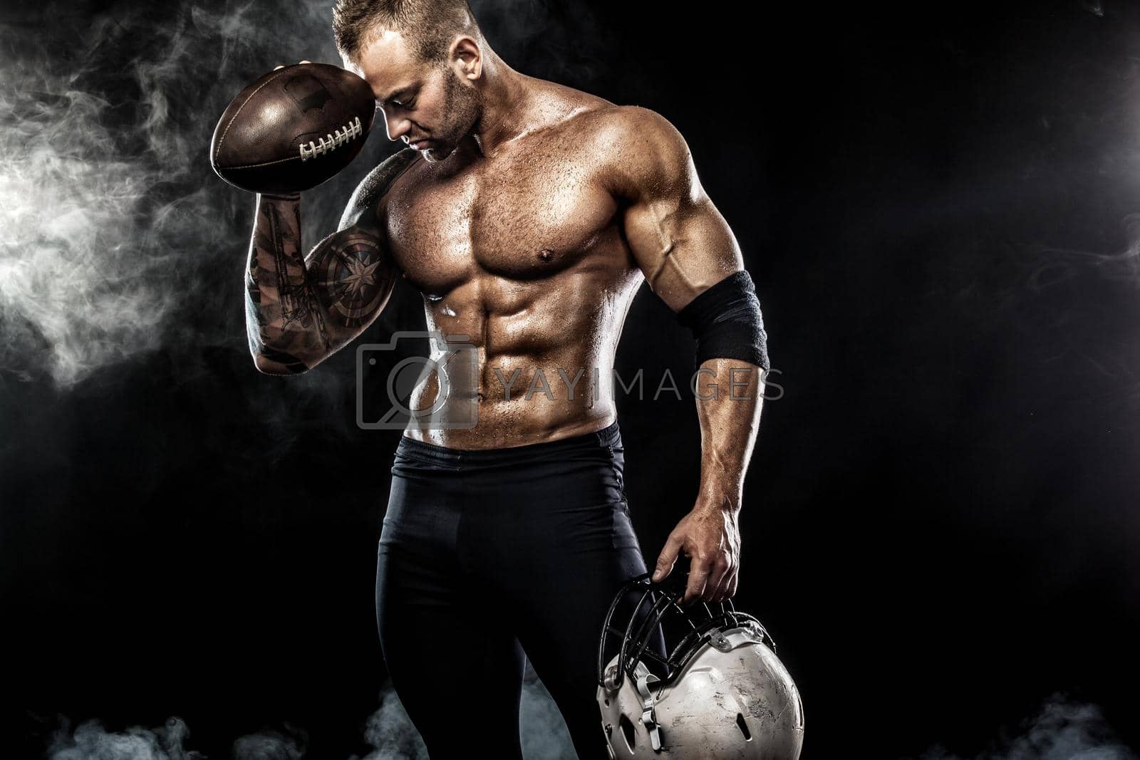 Royalty free image of American football sportsman player isolated on black background by MikeOrlov