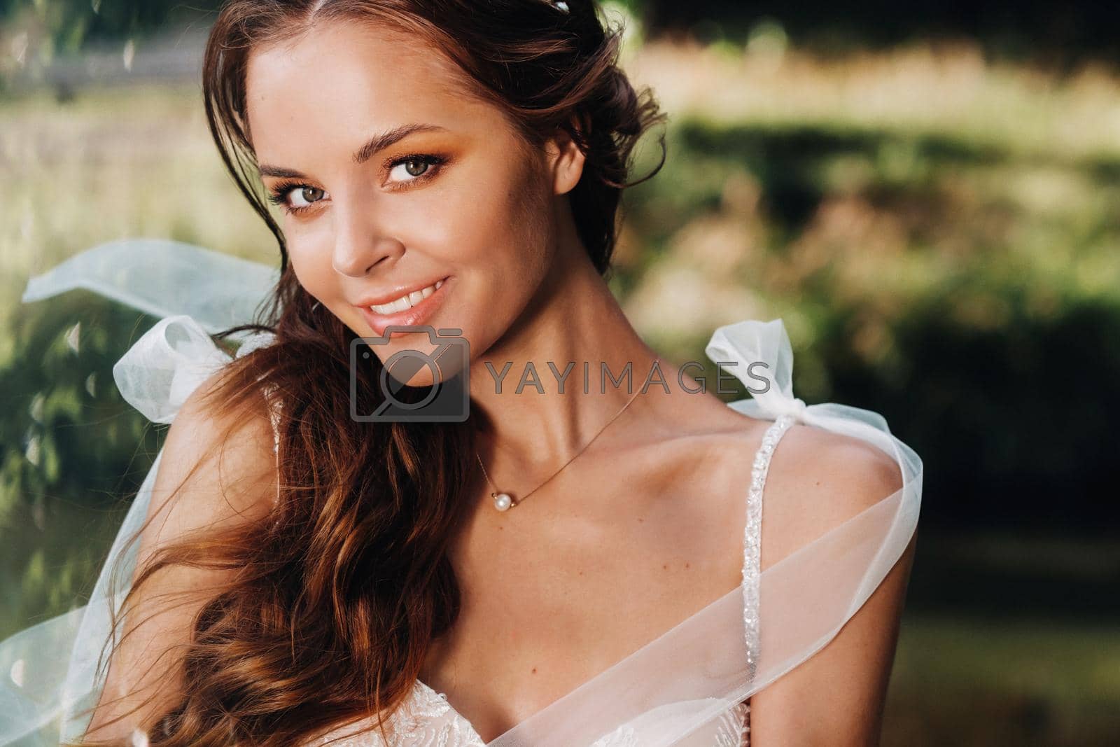 Royalty free image of Close-up portrait of an Elegant bride in a white dress in nature in a nature Park.Model in a wedding dress and gloves .Belarus by Lobachad
