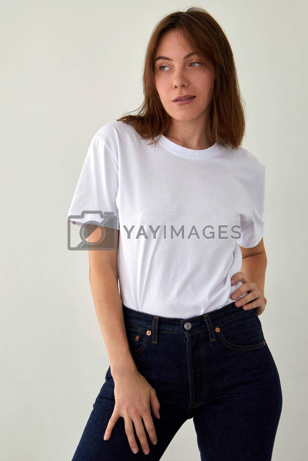 Royalty free image of Cute woman in casual outfit standing in studio by Demkat