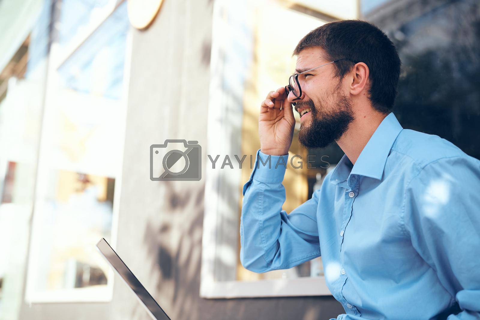 man in blue shirt laptop communication technology. High quality photo