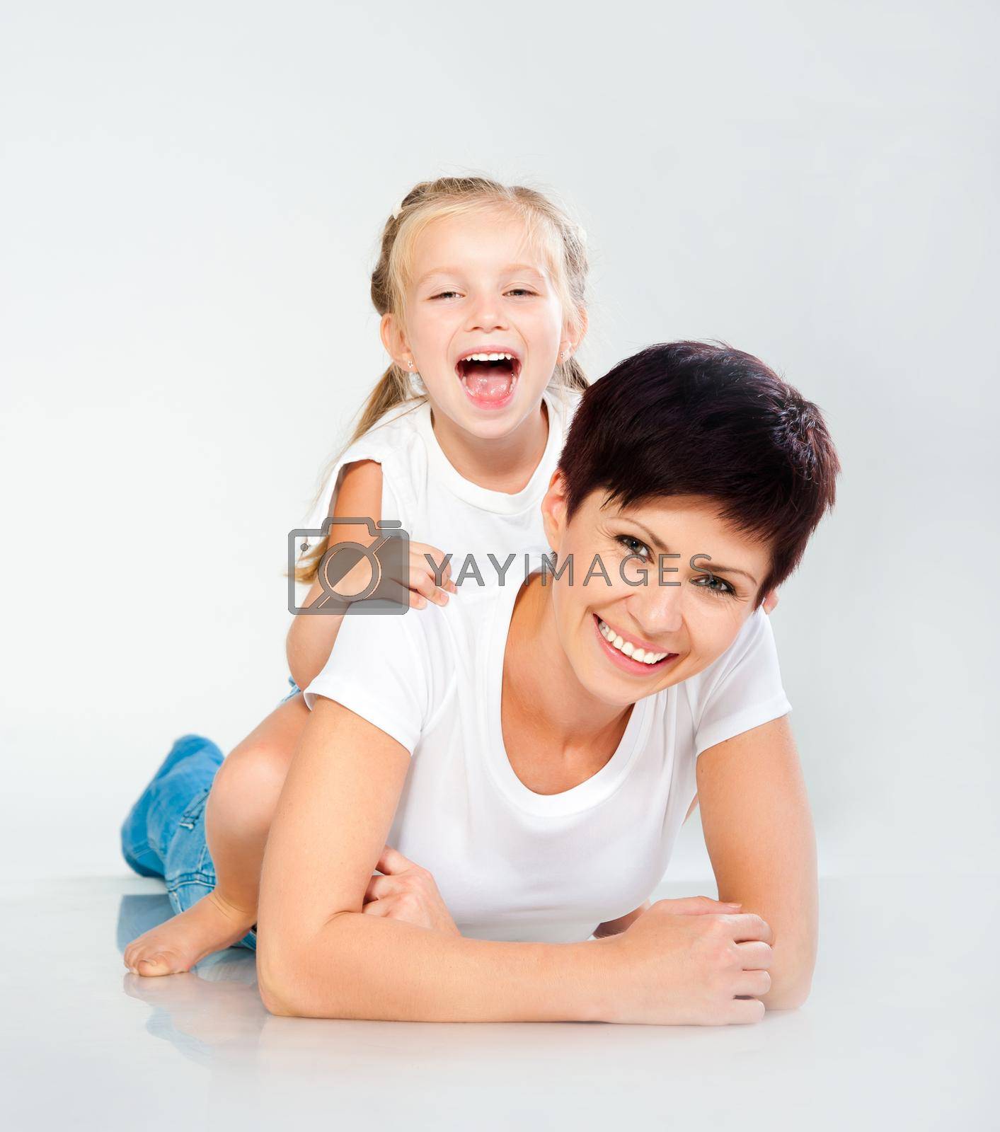 Mother and daughter laughing and looking at camera