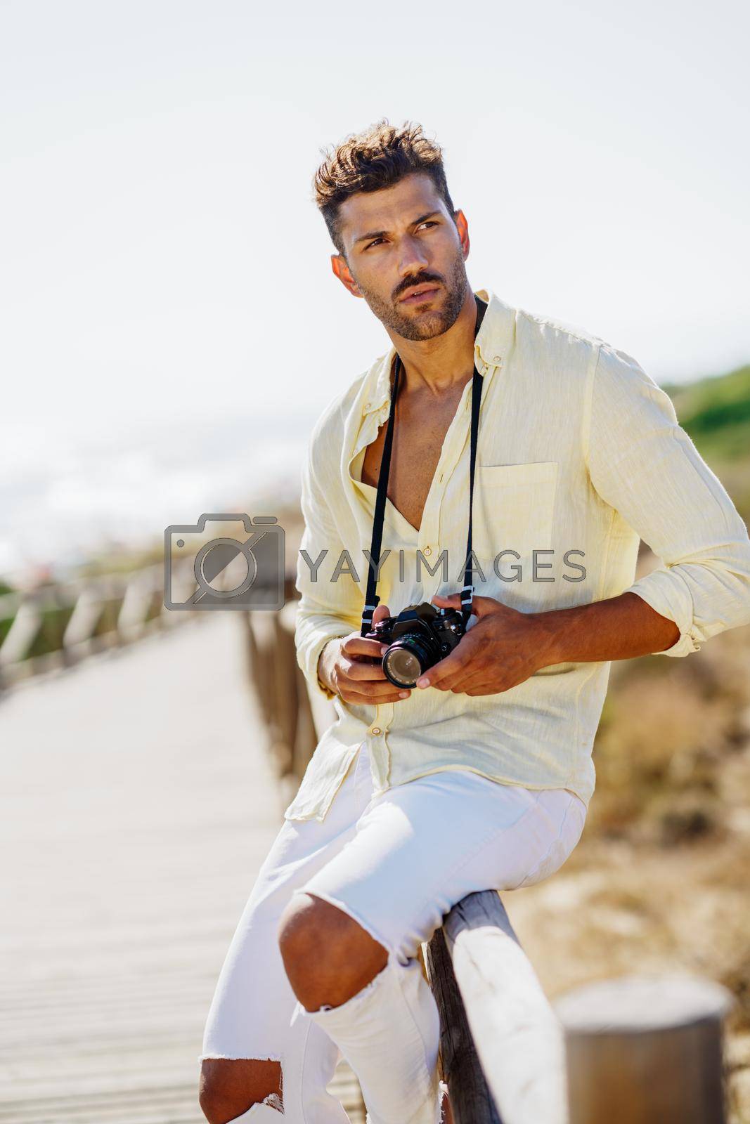 Royalty free image of Handsome man photographing in a coastal area. by javiindy
