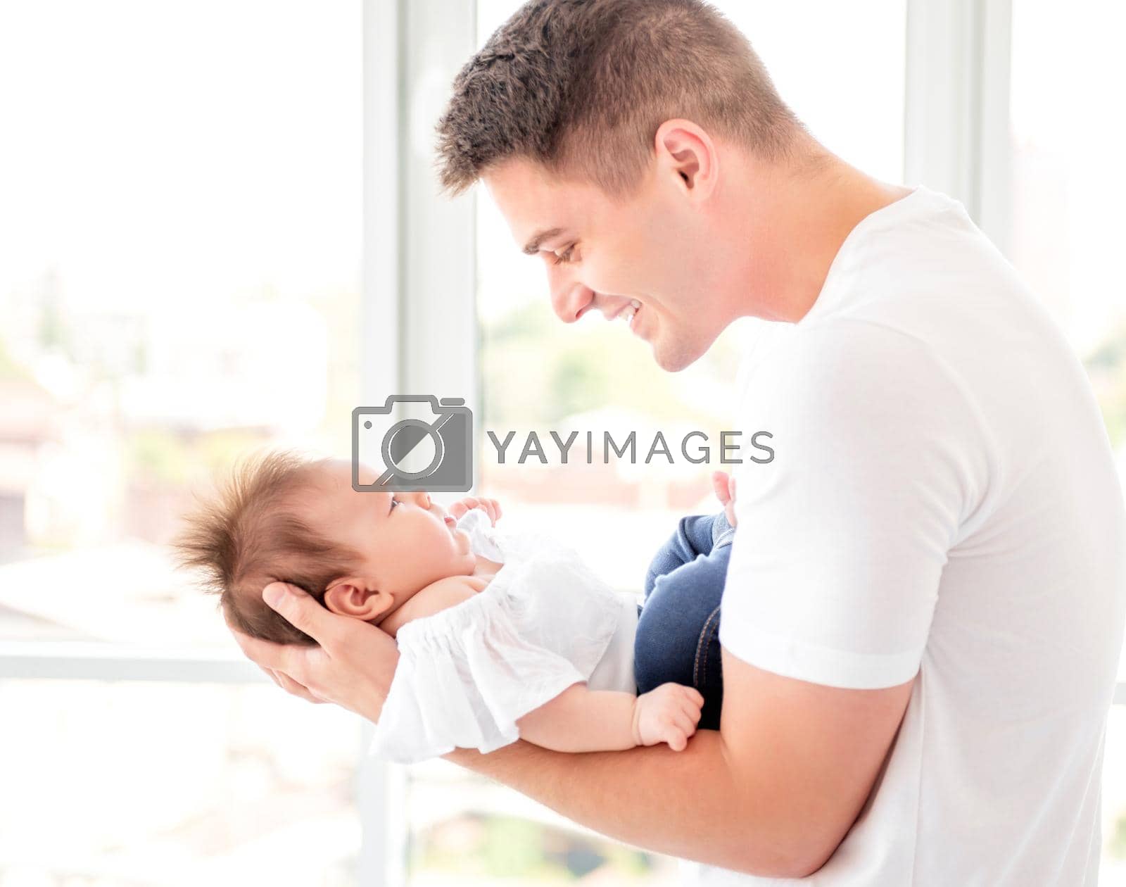 Royalty free image of Father embracing infant by tan4ikk1