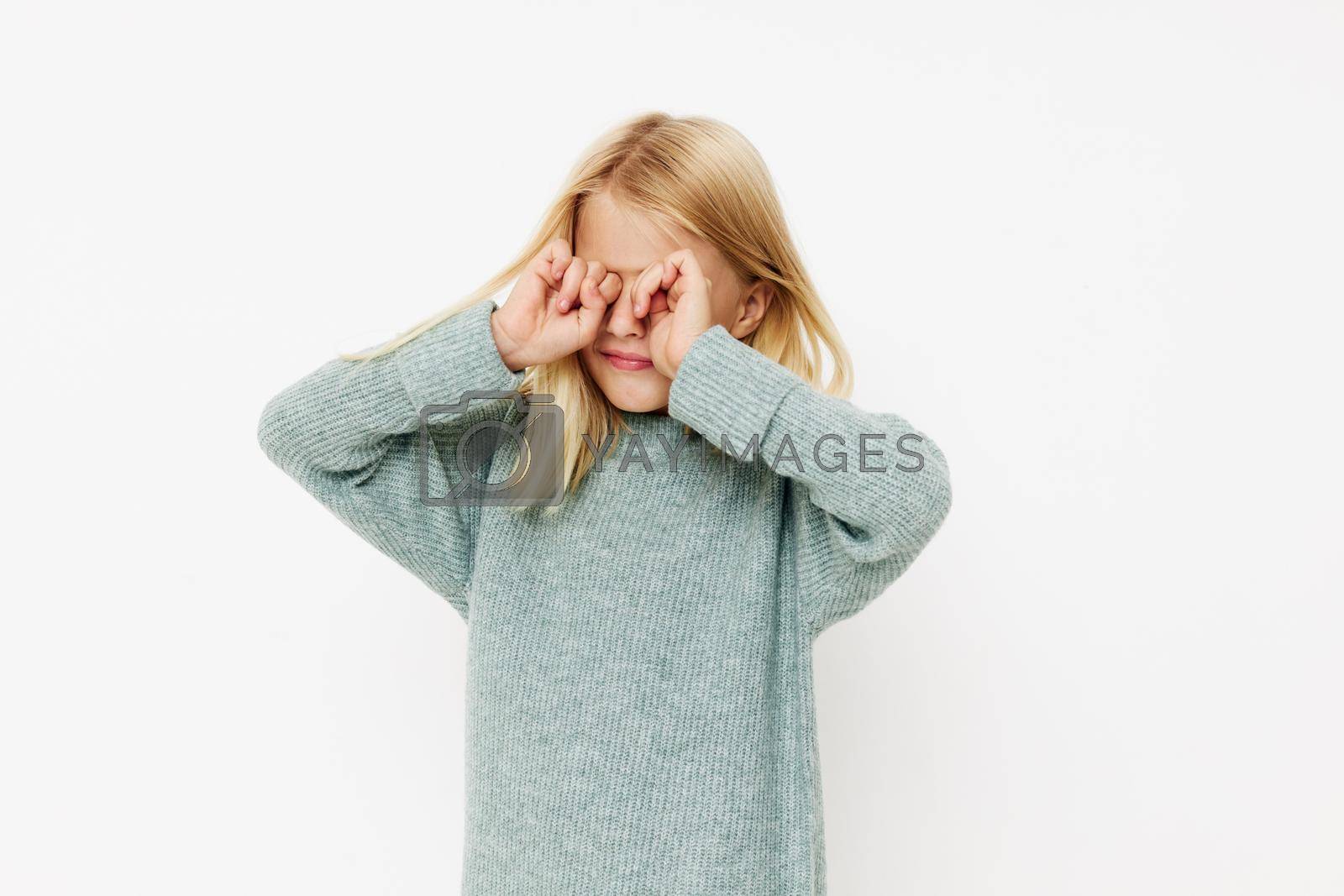 Royalty free image of happy cute girl in a sweater, grimaces cropped view by SHOTPRIME