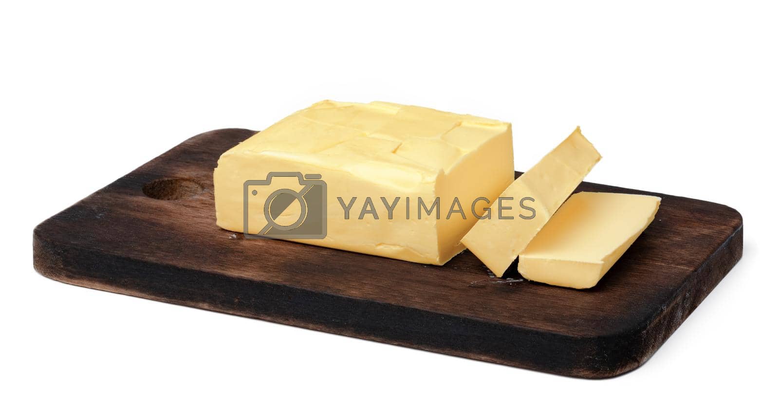 Royalty free image of Butter on wooden board isolated on white background by Fabrikasimf