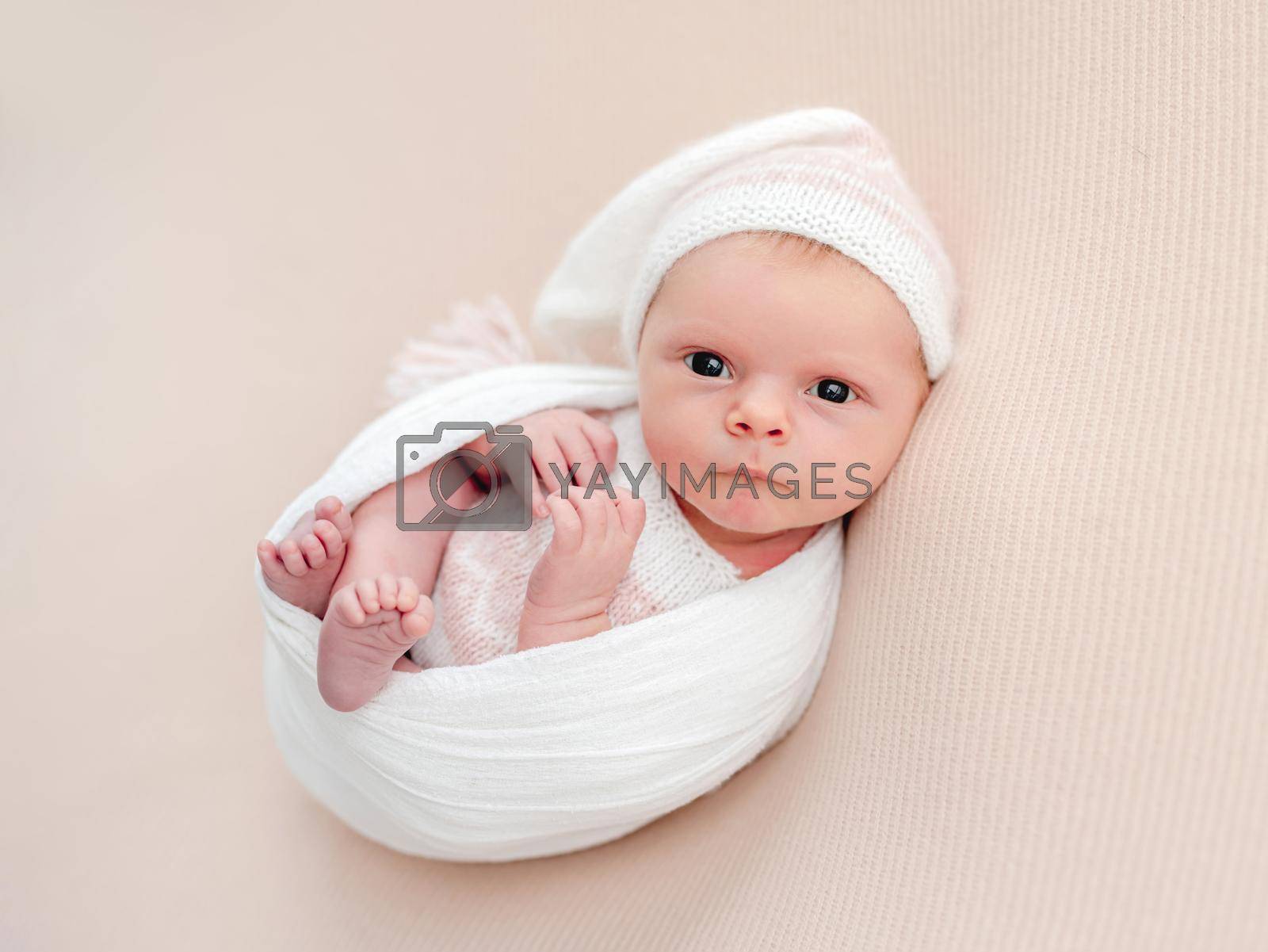 Royalty free image of Sleepless newborn in white suit and hat by tan4ikk1