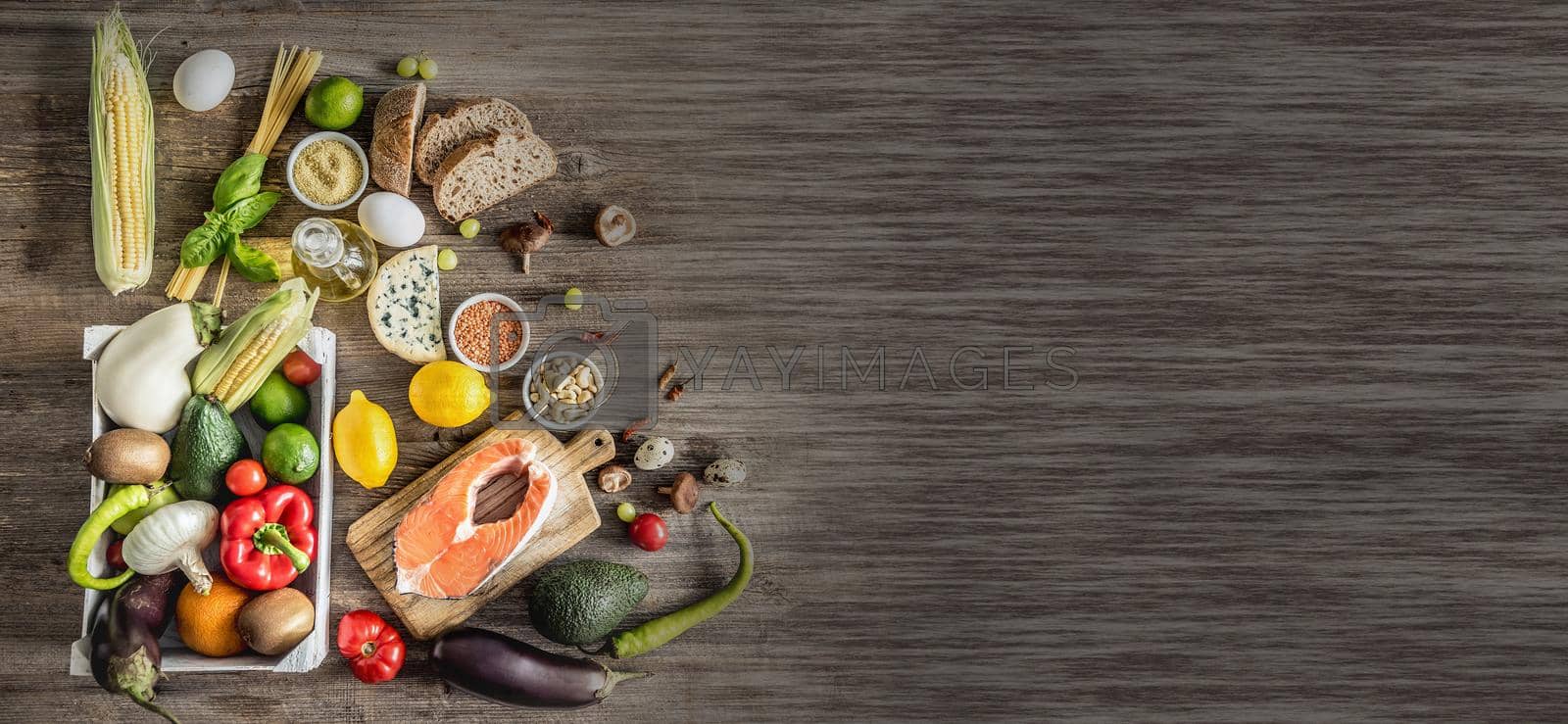 Royalty free image of Plenty of foods on the wooden table. by tan4ikk1