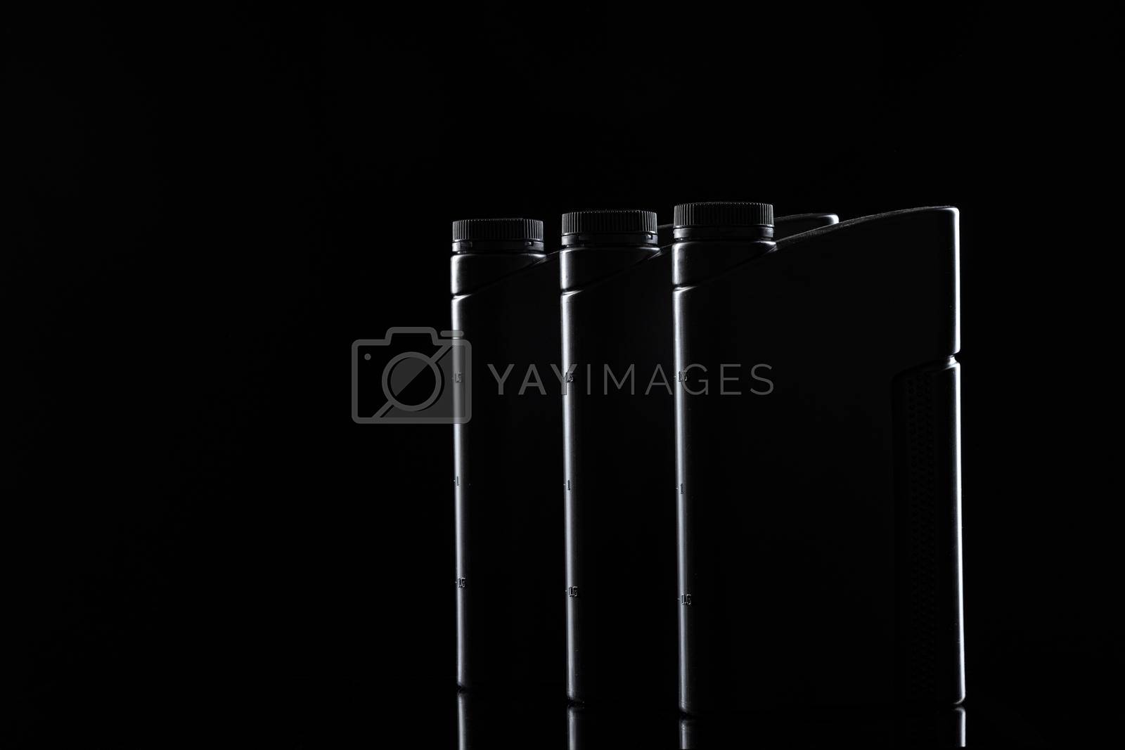 Royalty free image of Engine oil bottle on black background, close up. by Fabrikasimf