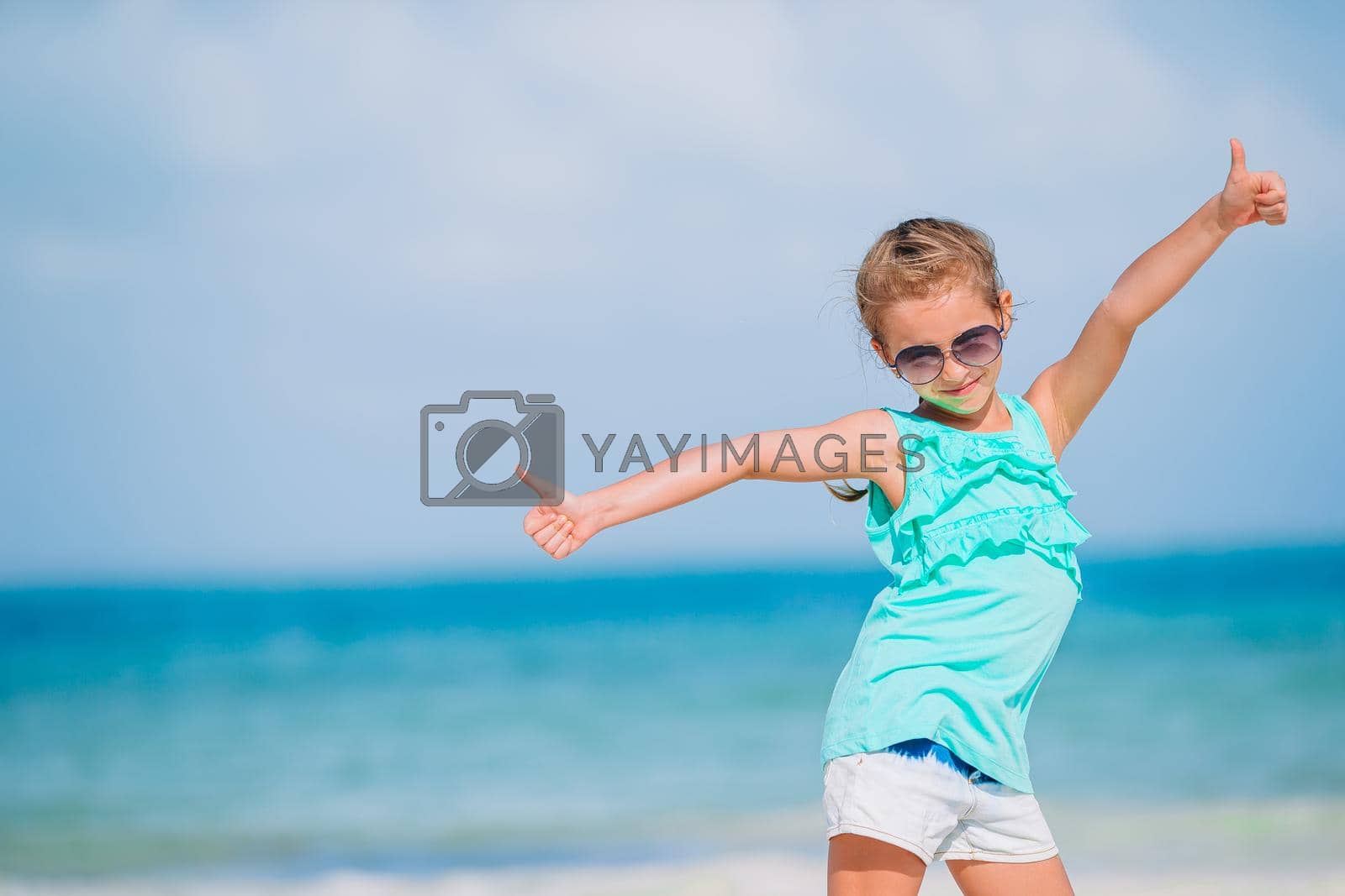 Royalty free image of Cute little girl at beach during caribbean vacation by travnikovstudio