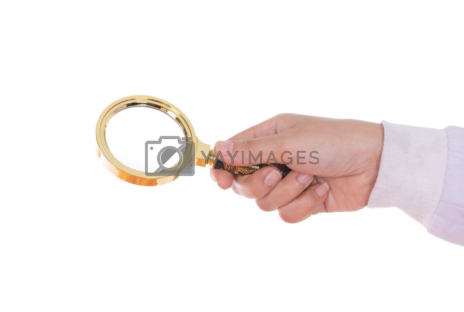 Royalty free image of hand holding a Brass Magnifying Glas by geargodz