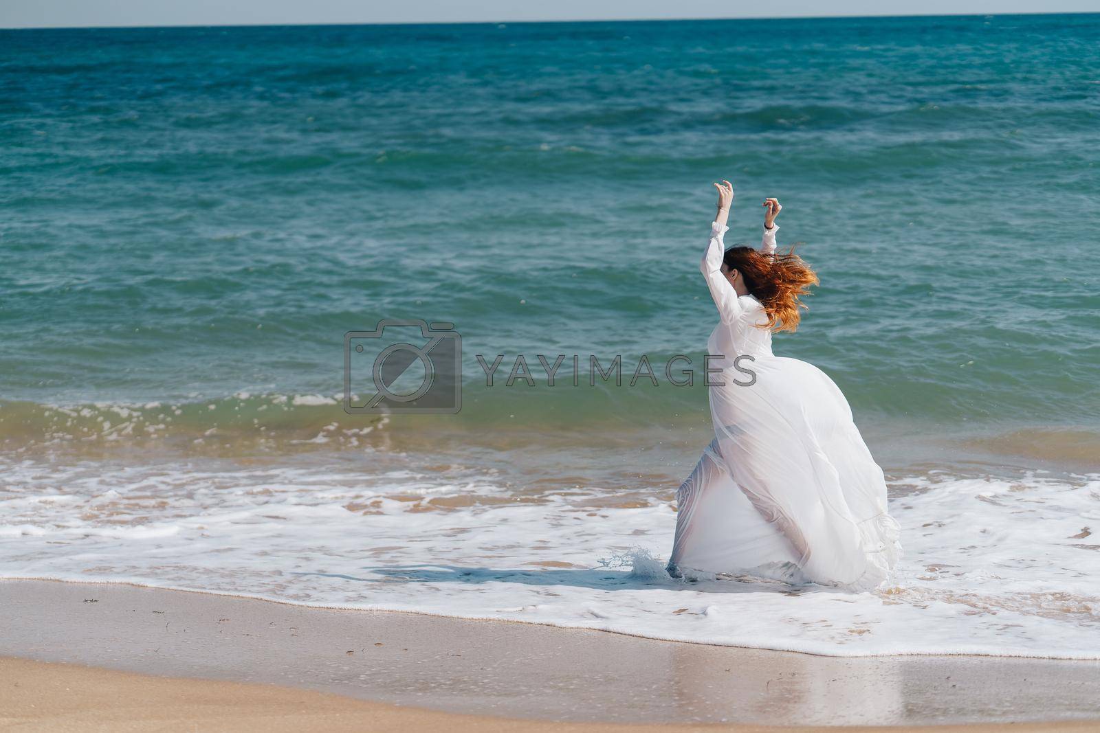 beautiful woman walks along the coast landscape ocean travel. High quality photo