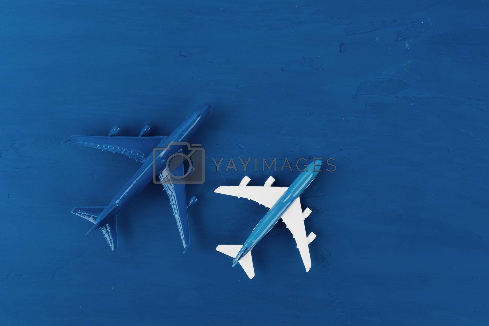 Toy plane on classic blue background, top view. High quality photo
