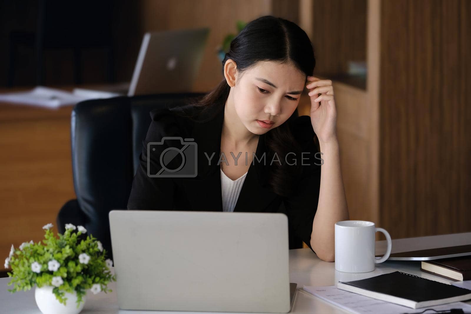 Royalty free image of Company employees show boredom from unfinished work using computer notebook, documents and tablets at work. by Manastrong