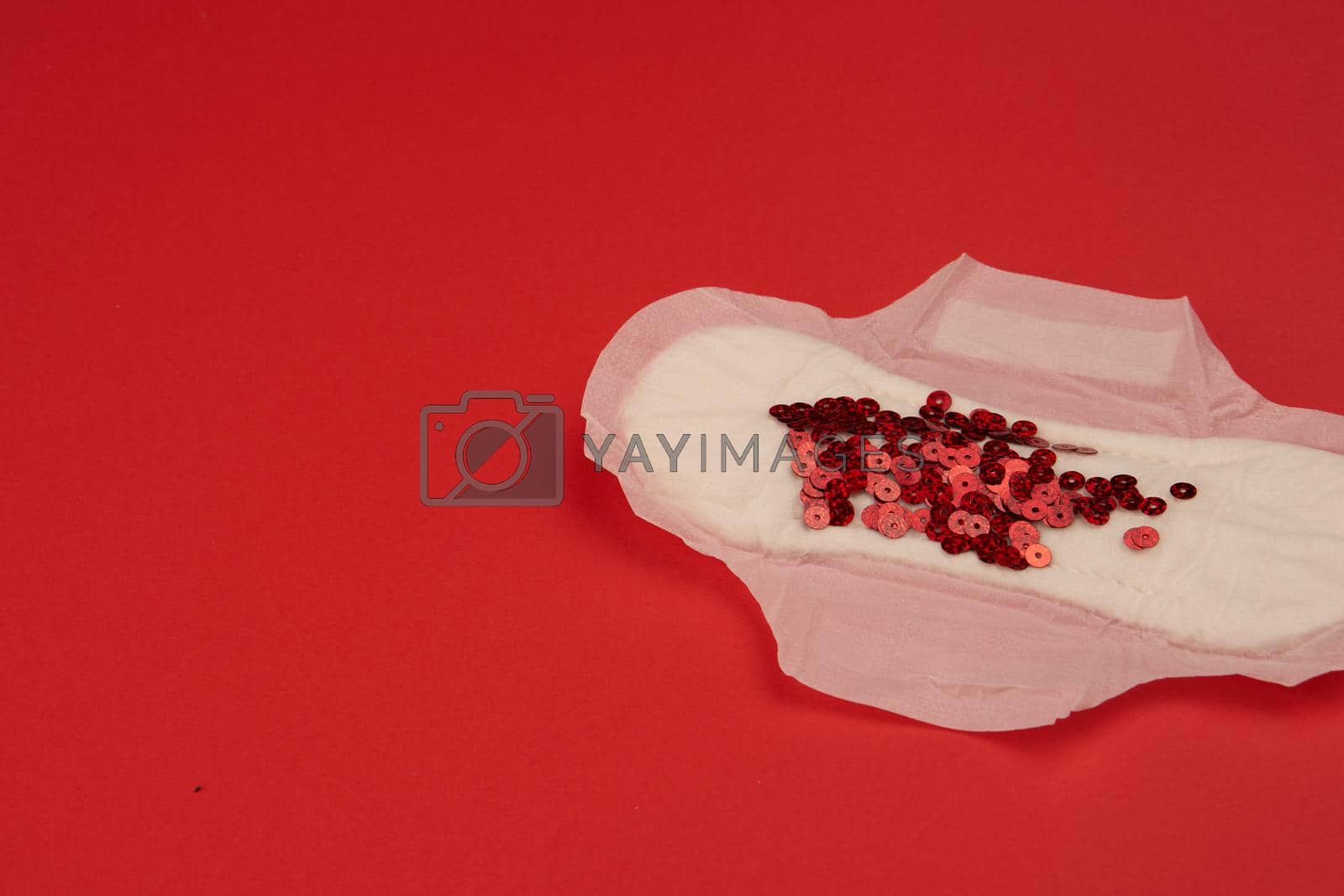 Royalty free image of feminine pad blood menstruation hygiene red background by Vichizh